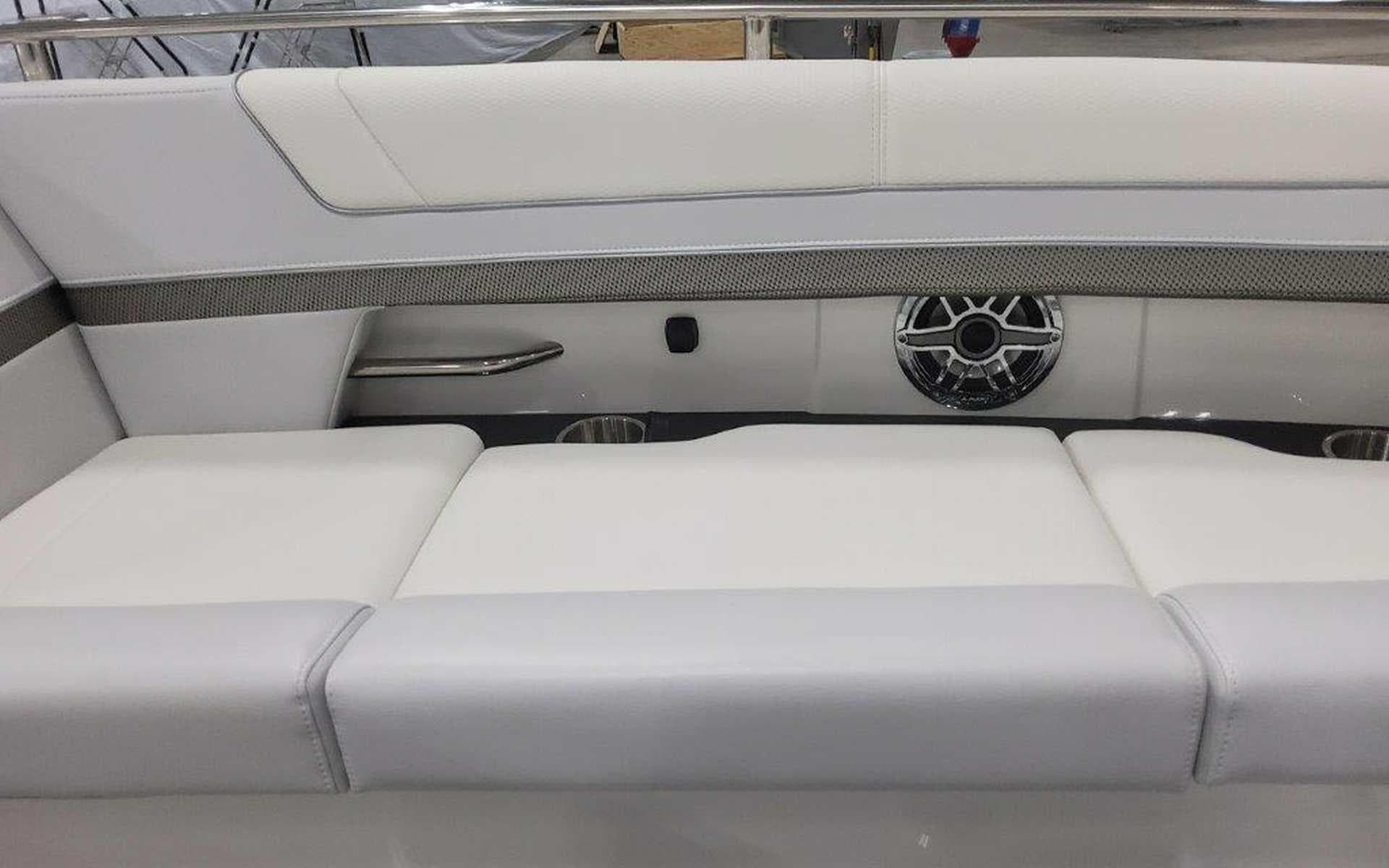2025 Formula 330 Crossover Bowrider I/O interior with white seating and speaker detail.