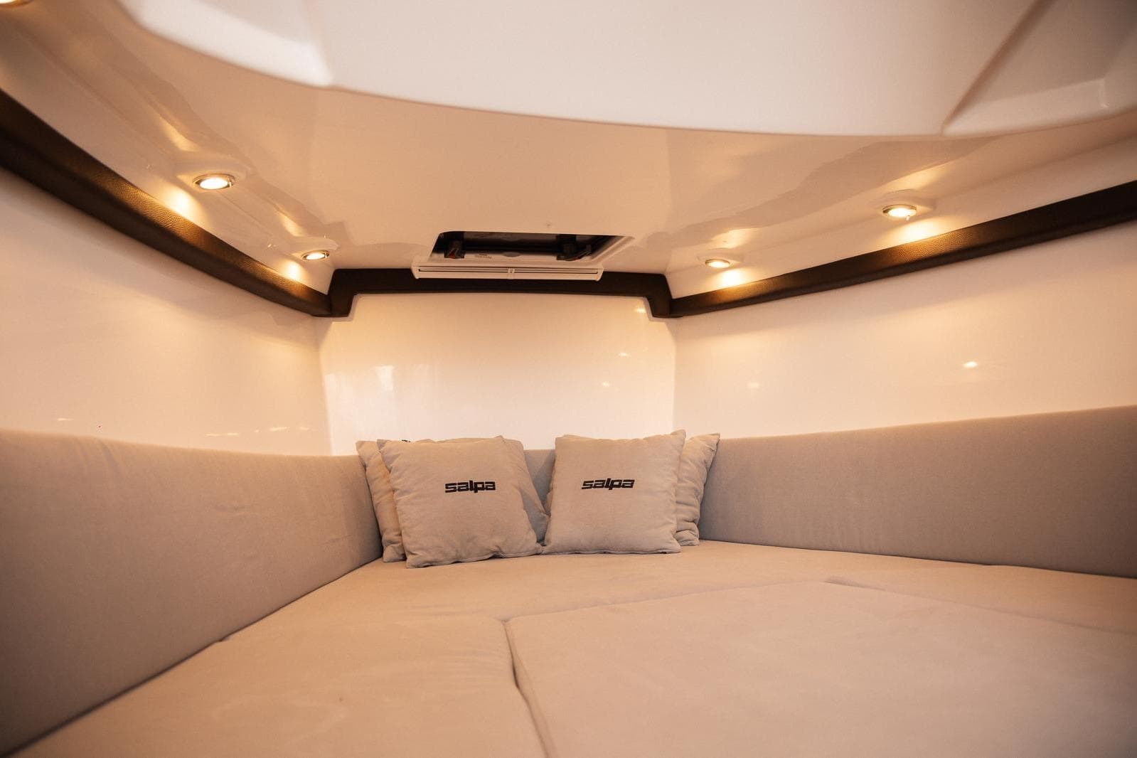 Luxurious interior of 2025 Salpa SOLEIL 33 boat with cozy seating and ambient lighting.
