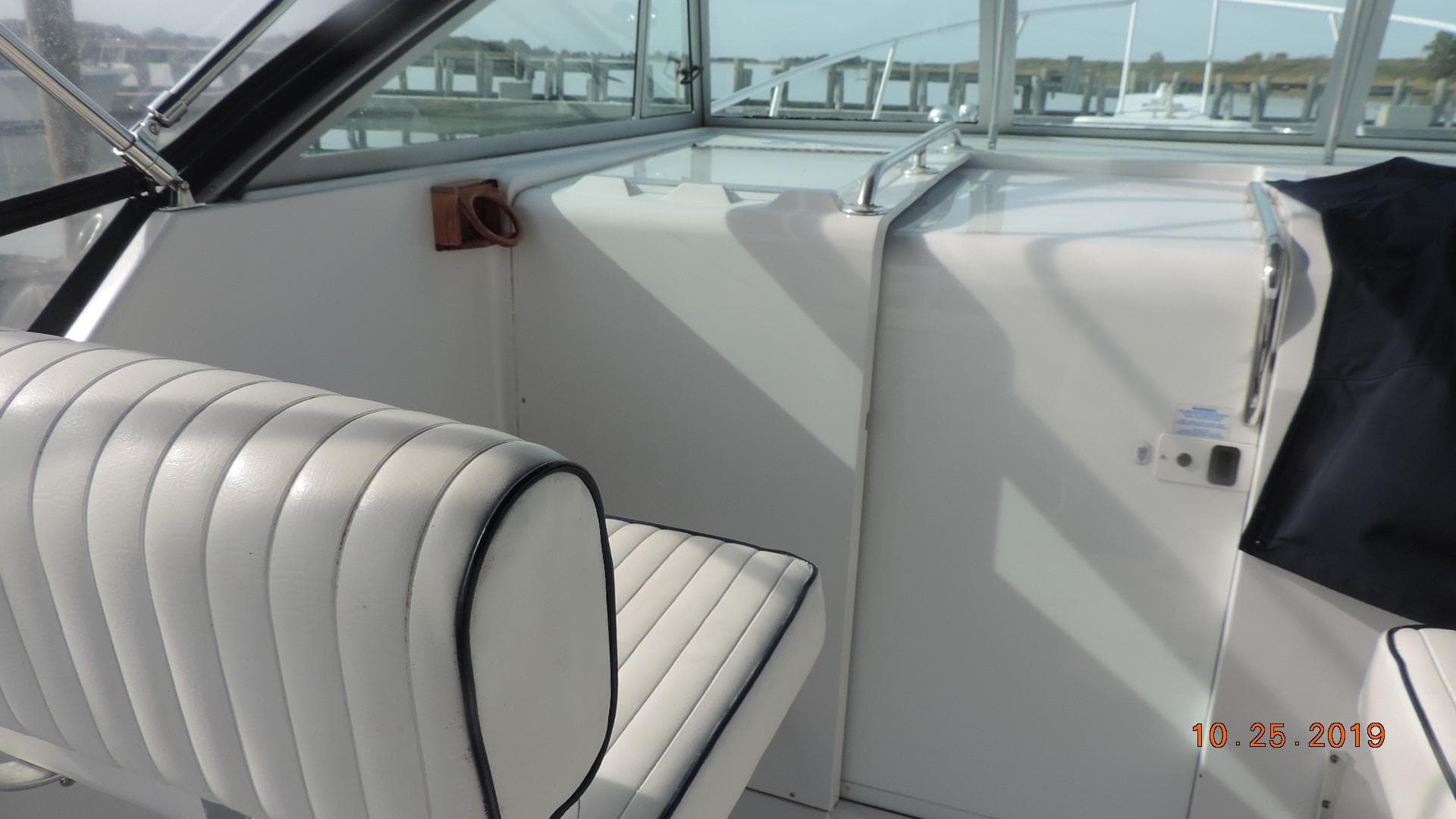 1998 Mainship 30 PILOT interior with white seating and helm area.