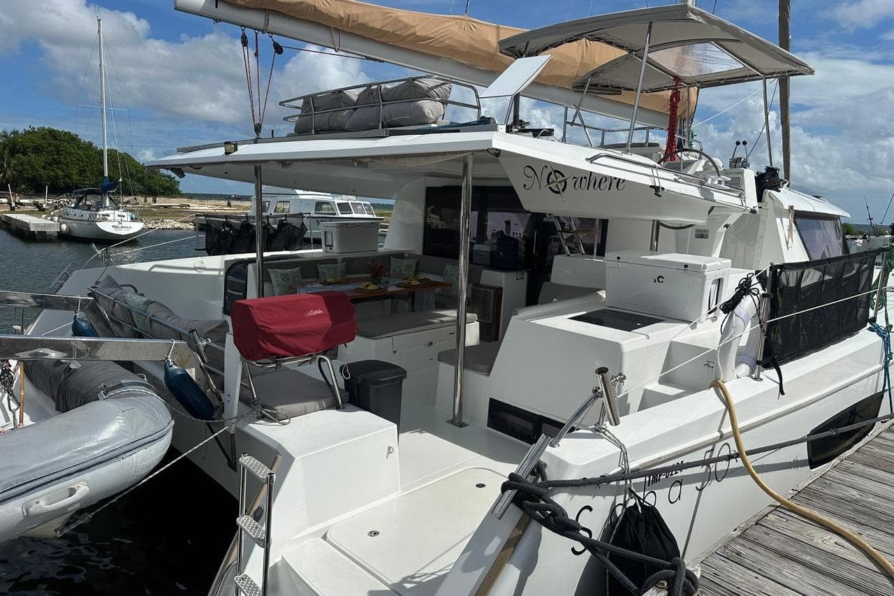 2016 Fountaine Pajot SABA 50 catamaran docked at marina, featuring spacious deck and equipment.