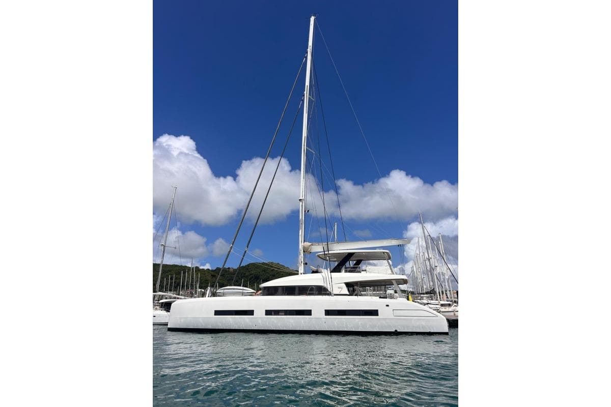 2023 Lagoon Seventy 7 yacht docked under clear blue sky.