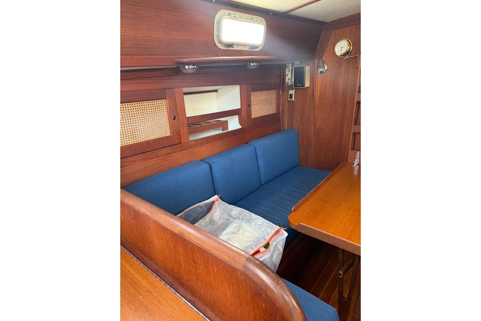 Interior of 1986 Tartan 37' sailboat with blue seating and wooden accents.
