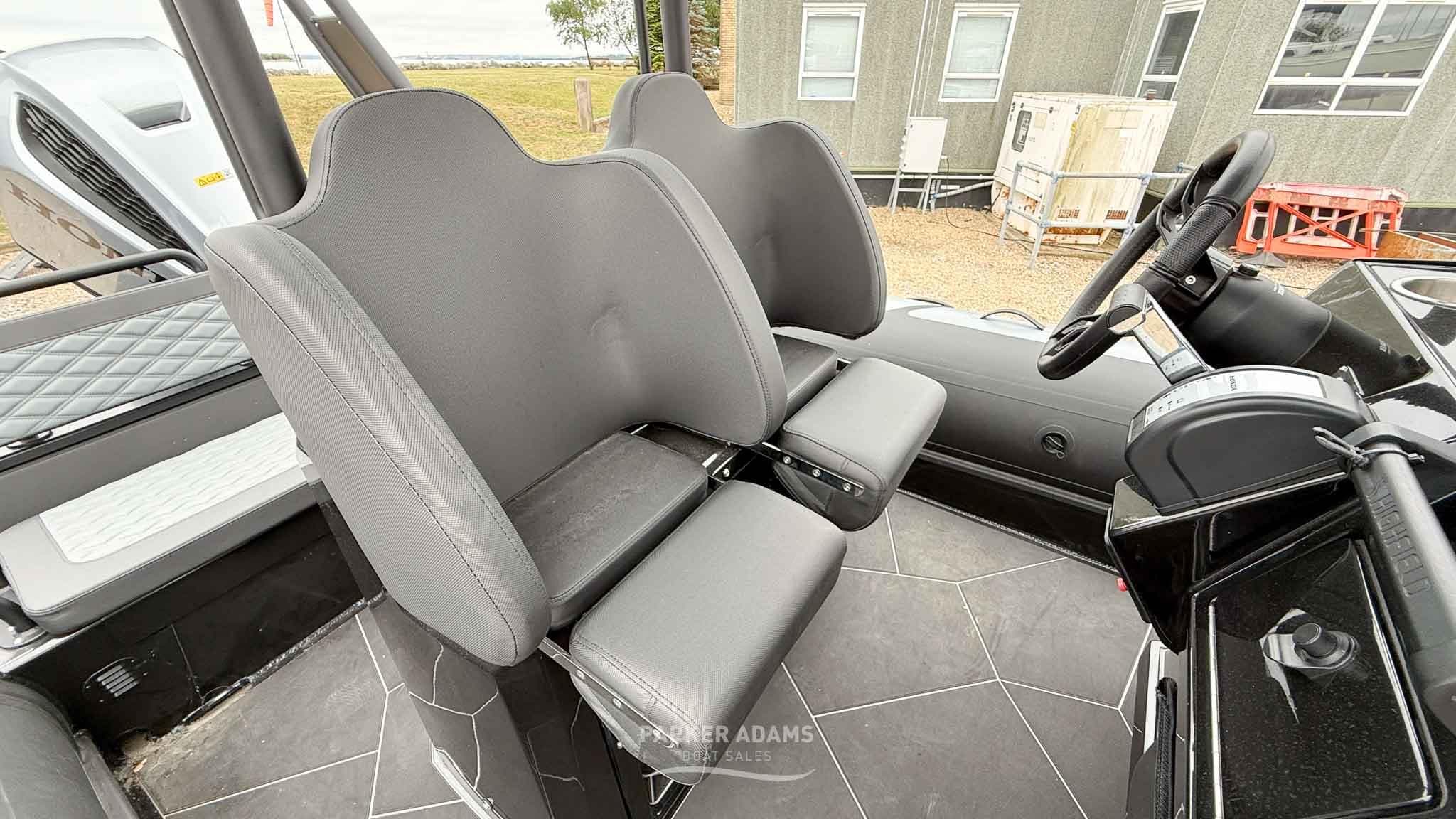 Interior of 2025 Highfield Sport 700 boat, featuring modern seating and steering console.
