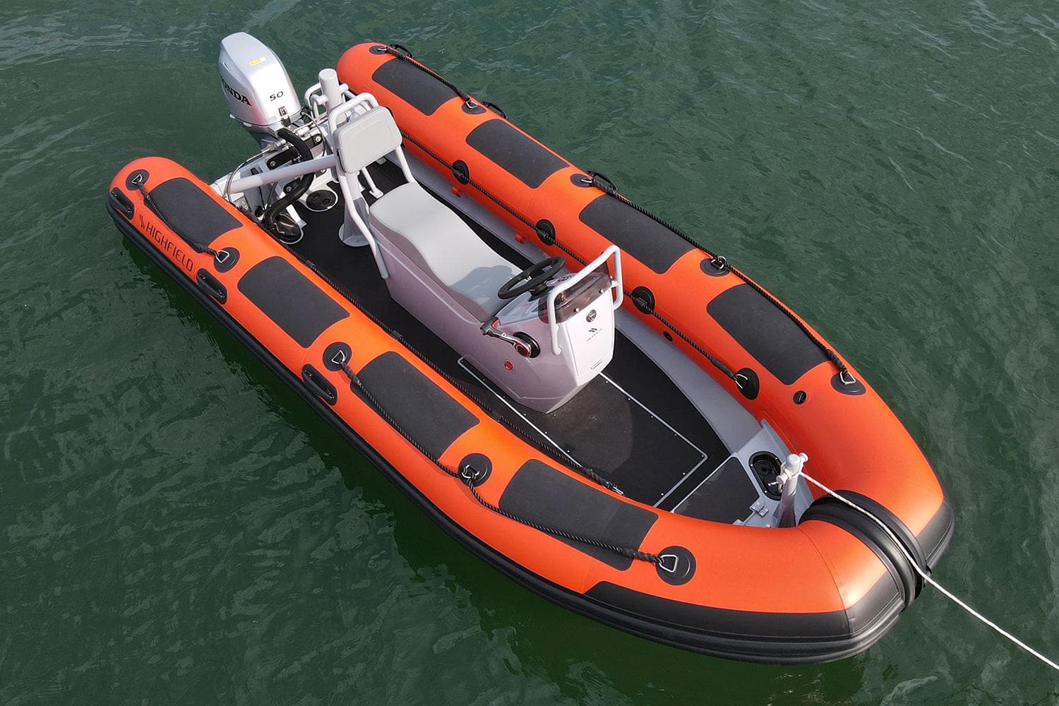 2024 Highfield Patrol 420 inflatable boat on water, featuring orange and black design.