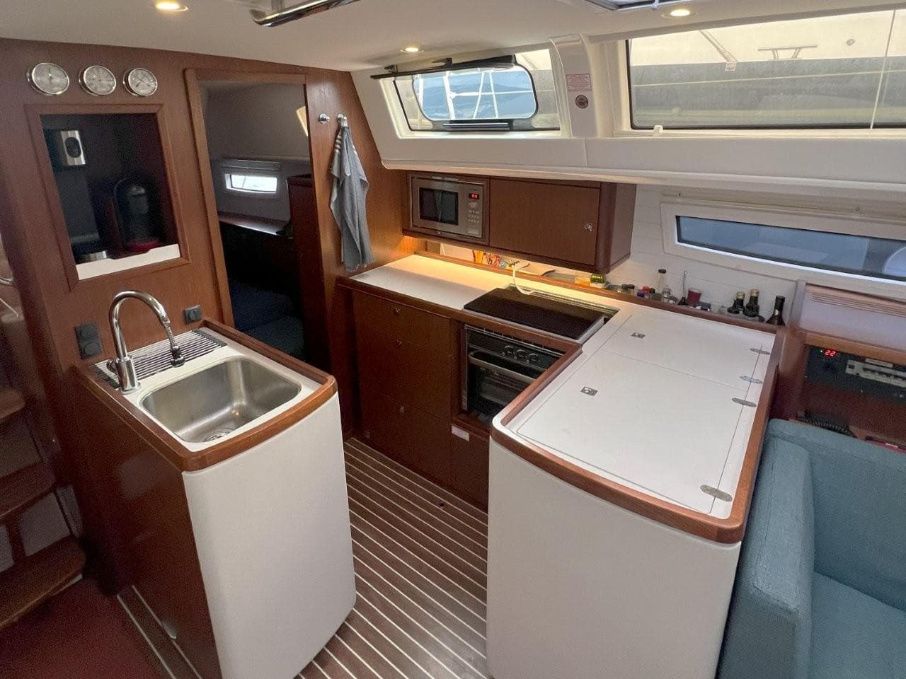 Interior of 2017 Bavaria 46 Vision yacht kitchen with modern amenities and wood finish.