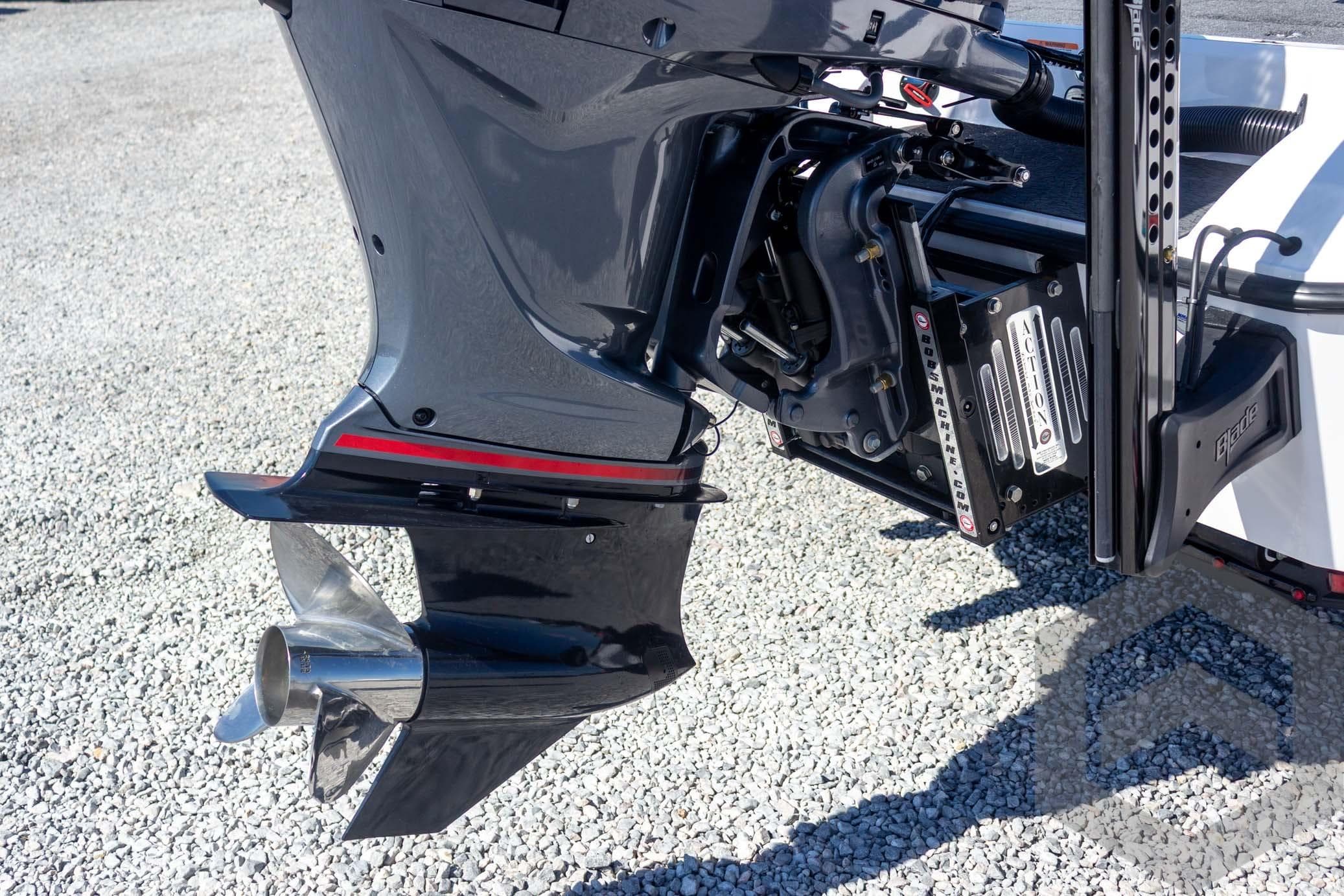 2026 Vexus VXs20 boat motor and propeller on gravel surface.