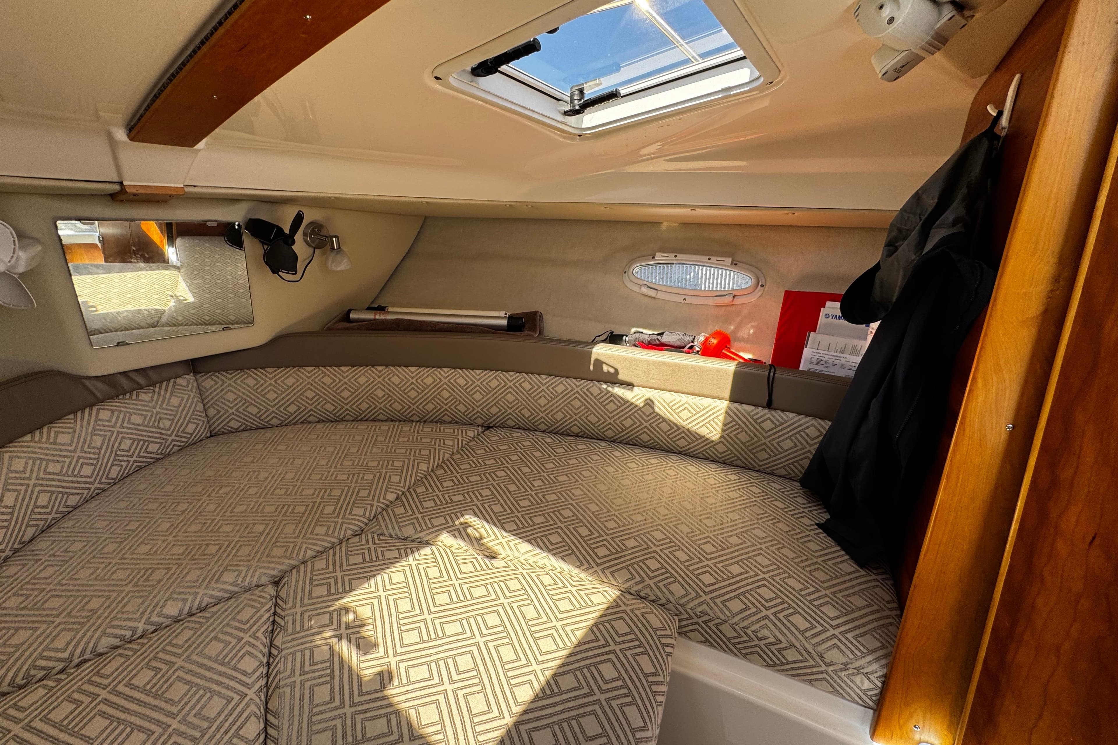 2022 Cutwater C-248 Coupe cabin interior with patterned cushions and natural light.