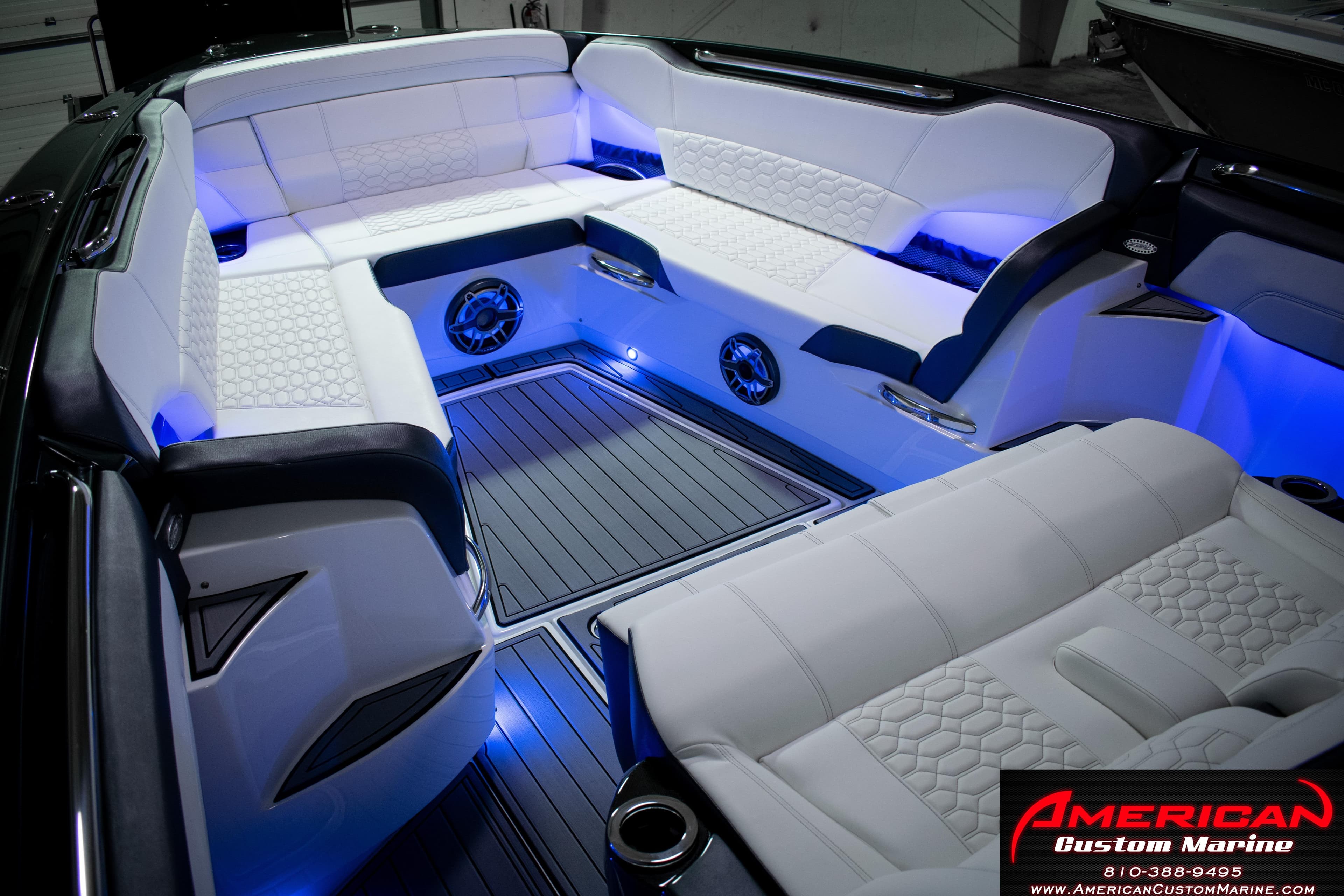 Luxurious interior of 2027 Nor-Tech 450 Sport Center Console with ambient blue lighting.