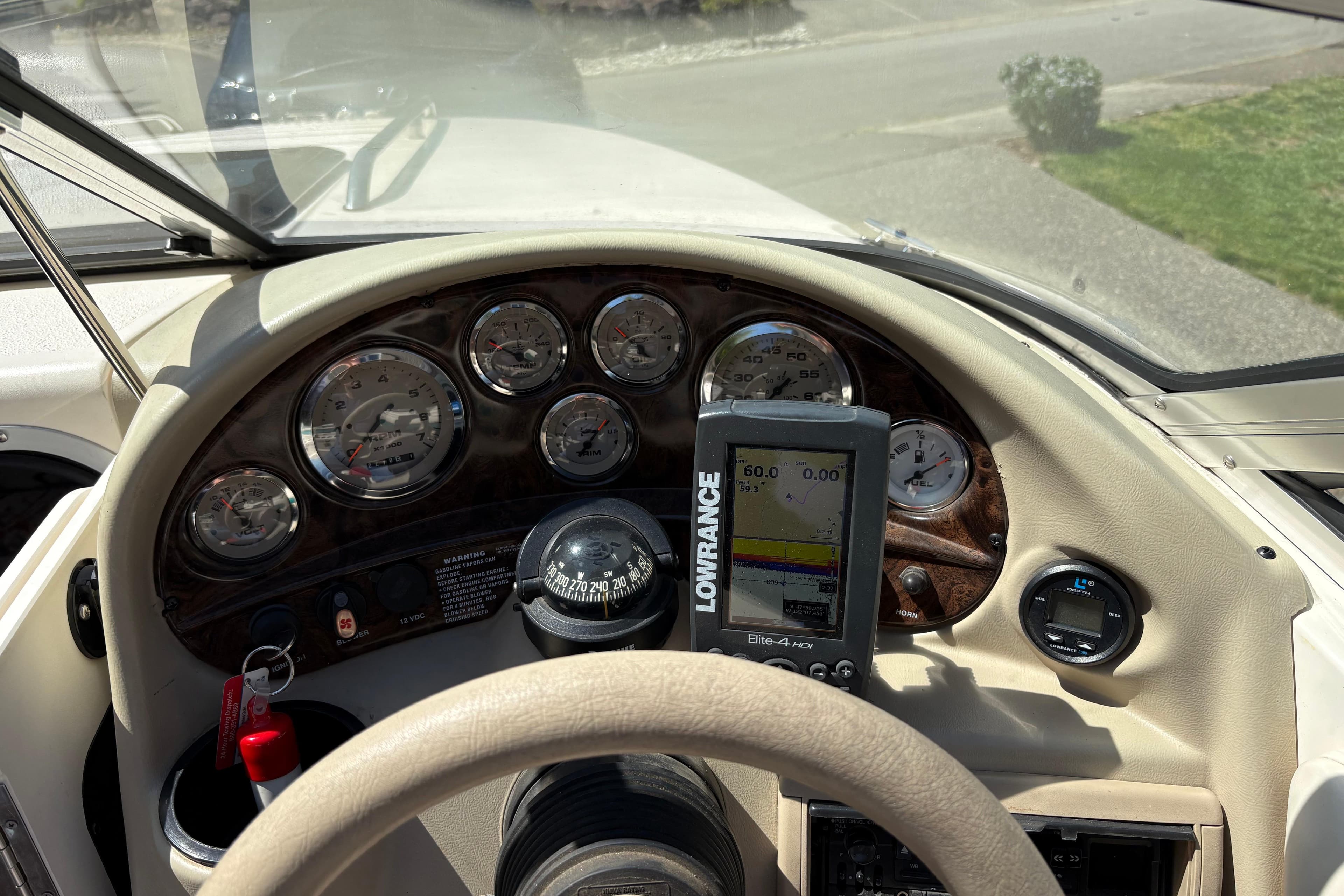 Dashboard of a 1997 Stingray 200 CS boat with gauges and Lowrance GPS.