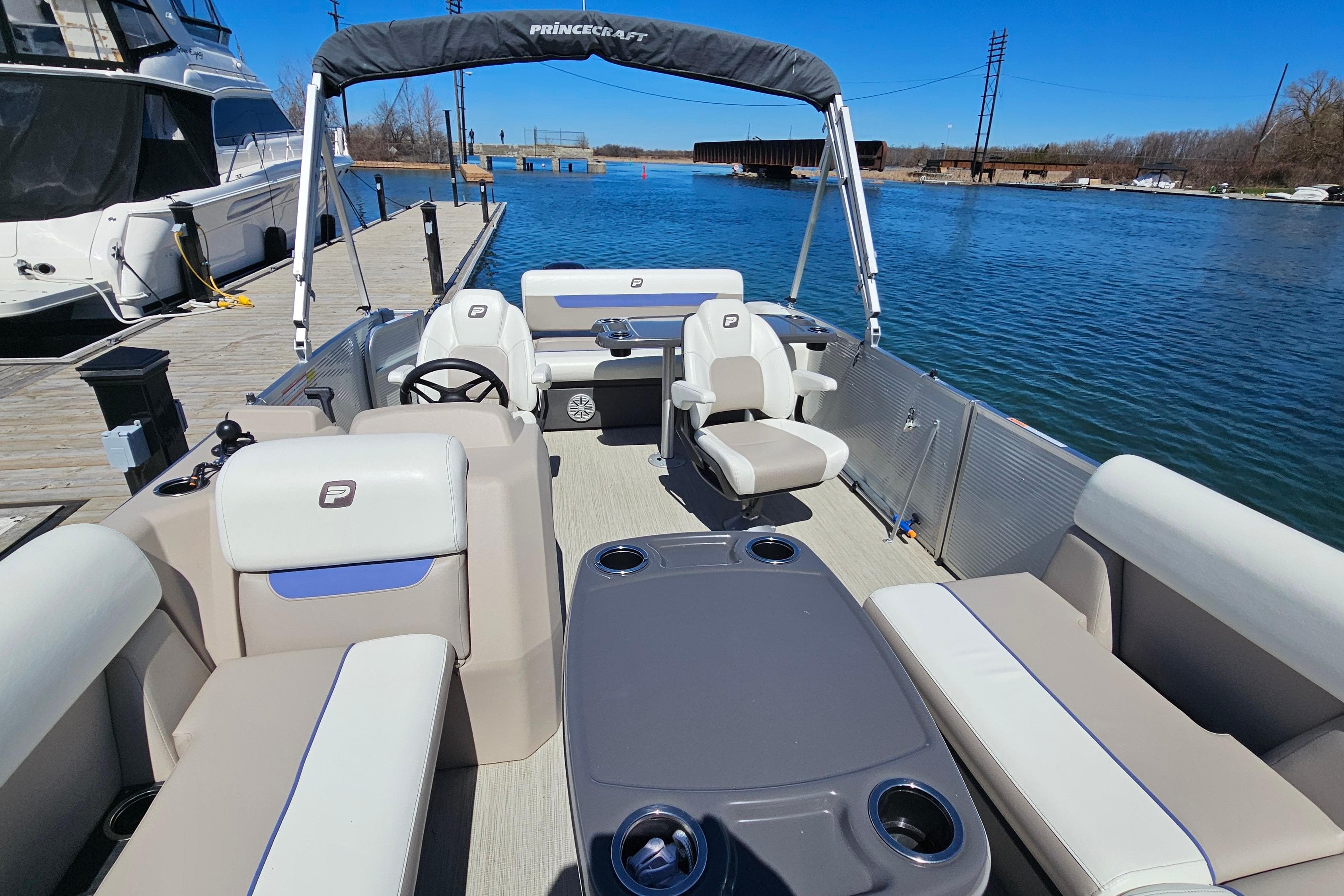 2024 Princecraft Vectra 21 RL pontoon boat docked on a sunny day.
