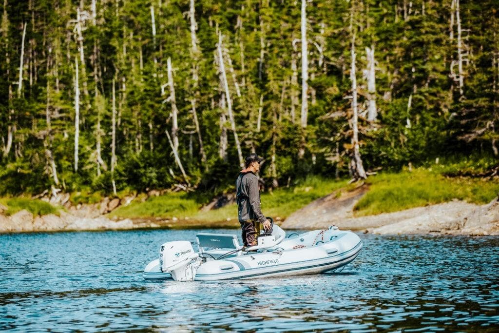 Man on Highfield Classic 340 boat in forested lake, 2026 model.