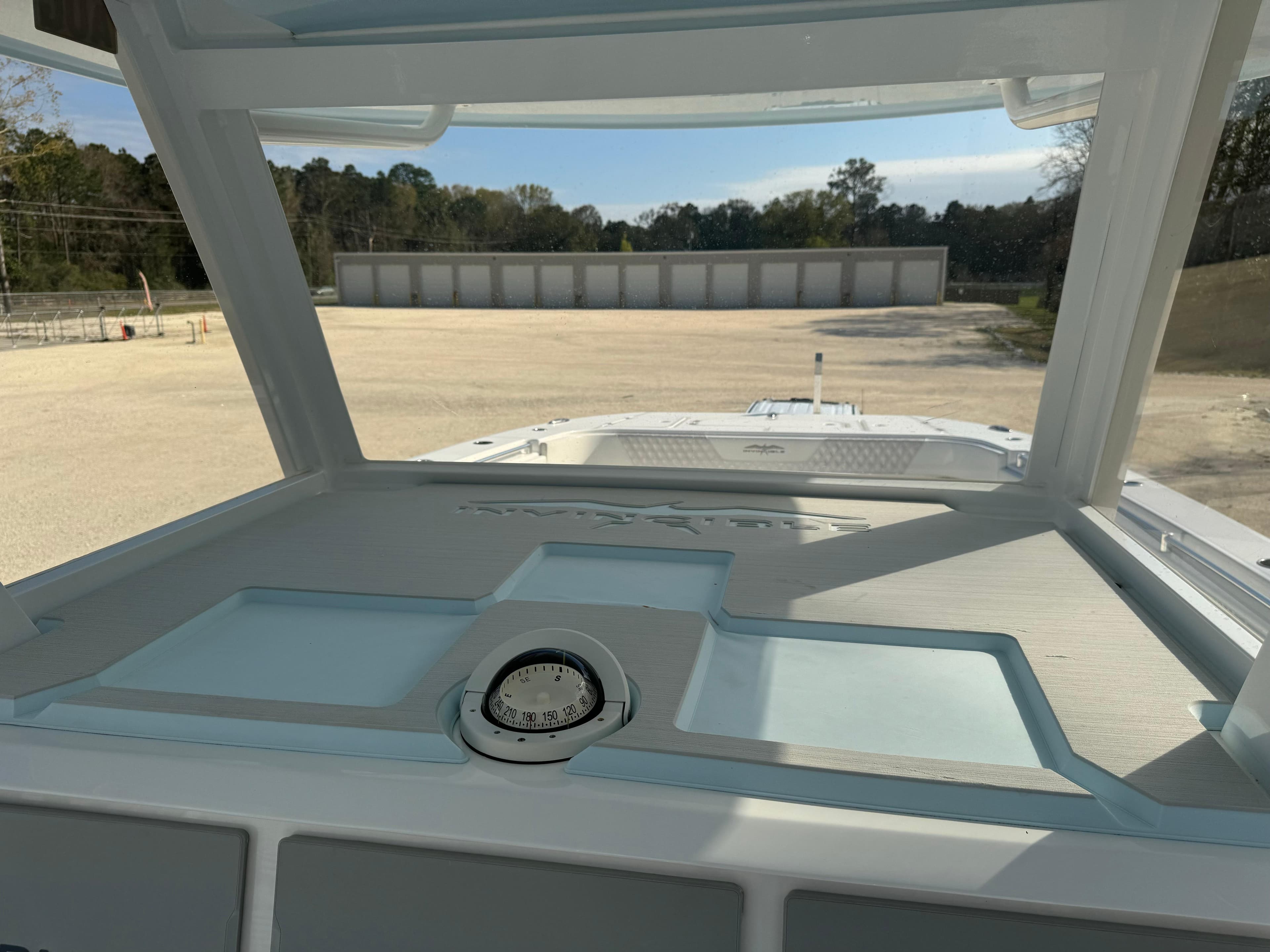 2020 Invincible 37 Catamaran dashboard view with open storage compartments.