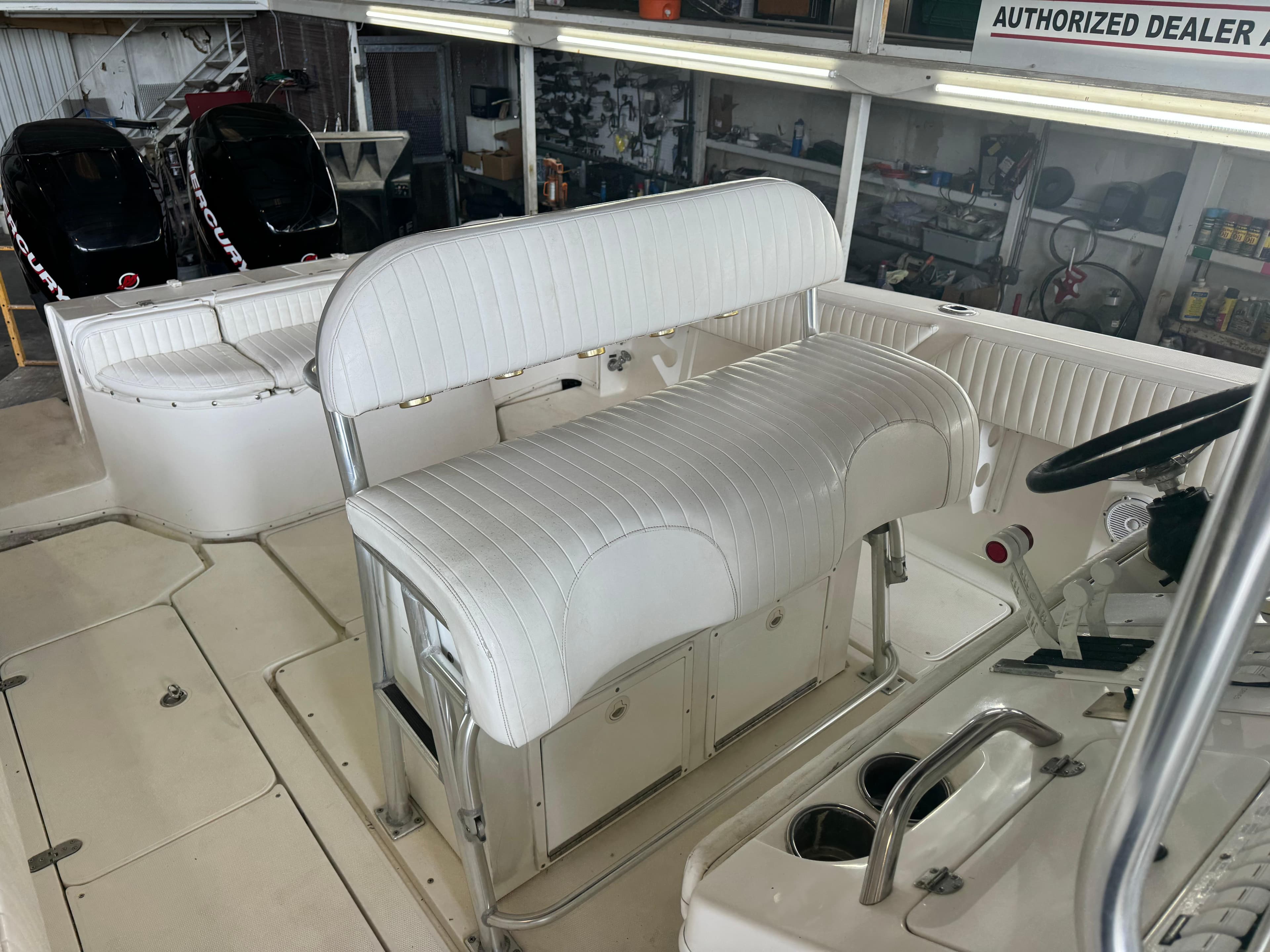2007 Fountain 32 CC boat interior with white seating and dual Mercury engines.