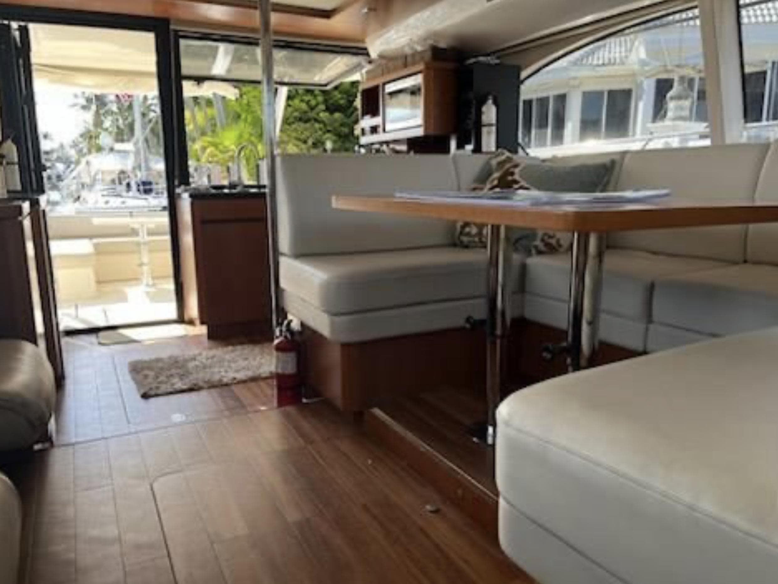 Interior of 2016 Aquila 44 Yacht with elegant seating and wooden flooring.