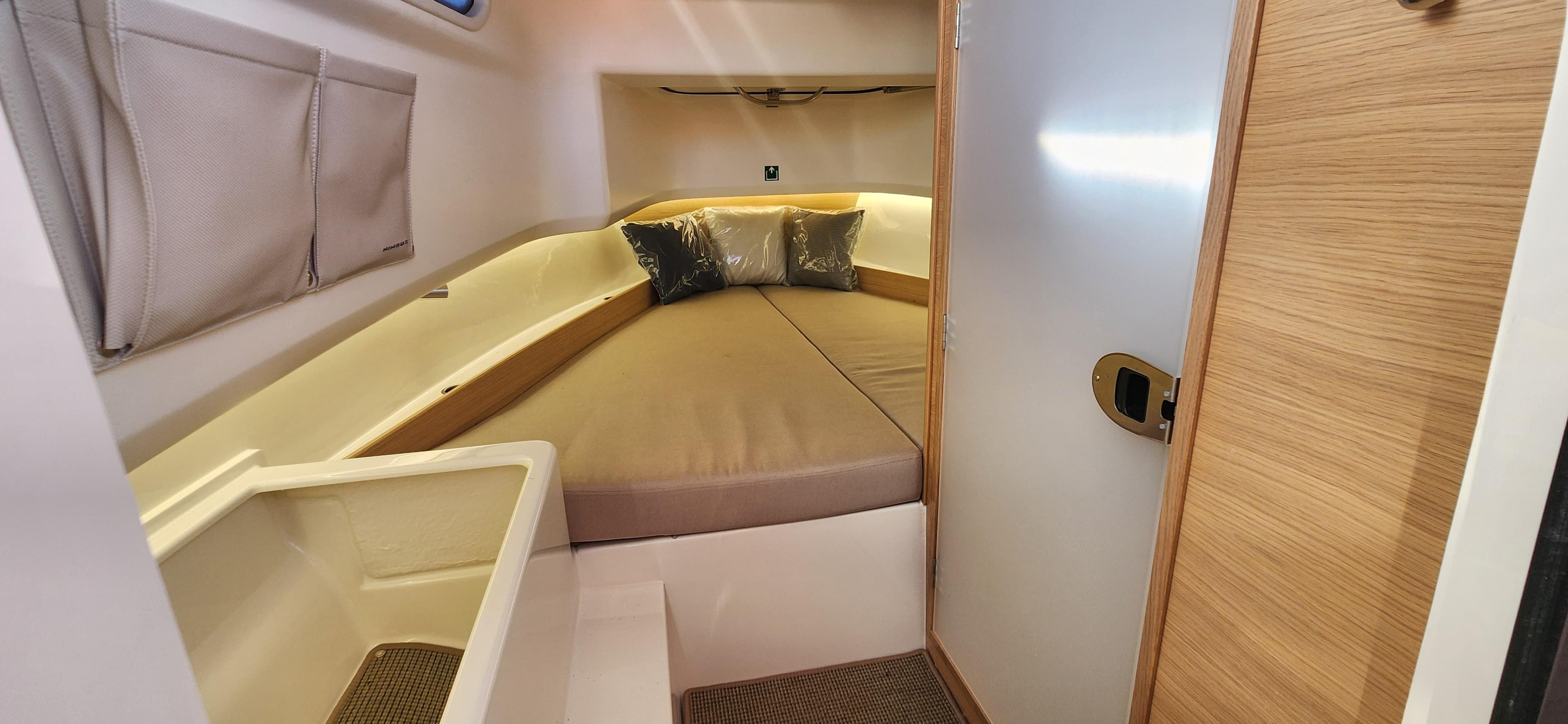 2023 Nimbus T8 cabin interior with cozy bed and modern design.