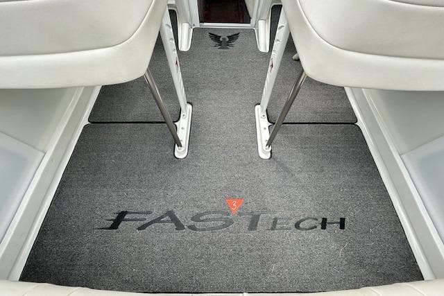 2004 Formula 292 FASTech boat interior with branded carpet and white seating.