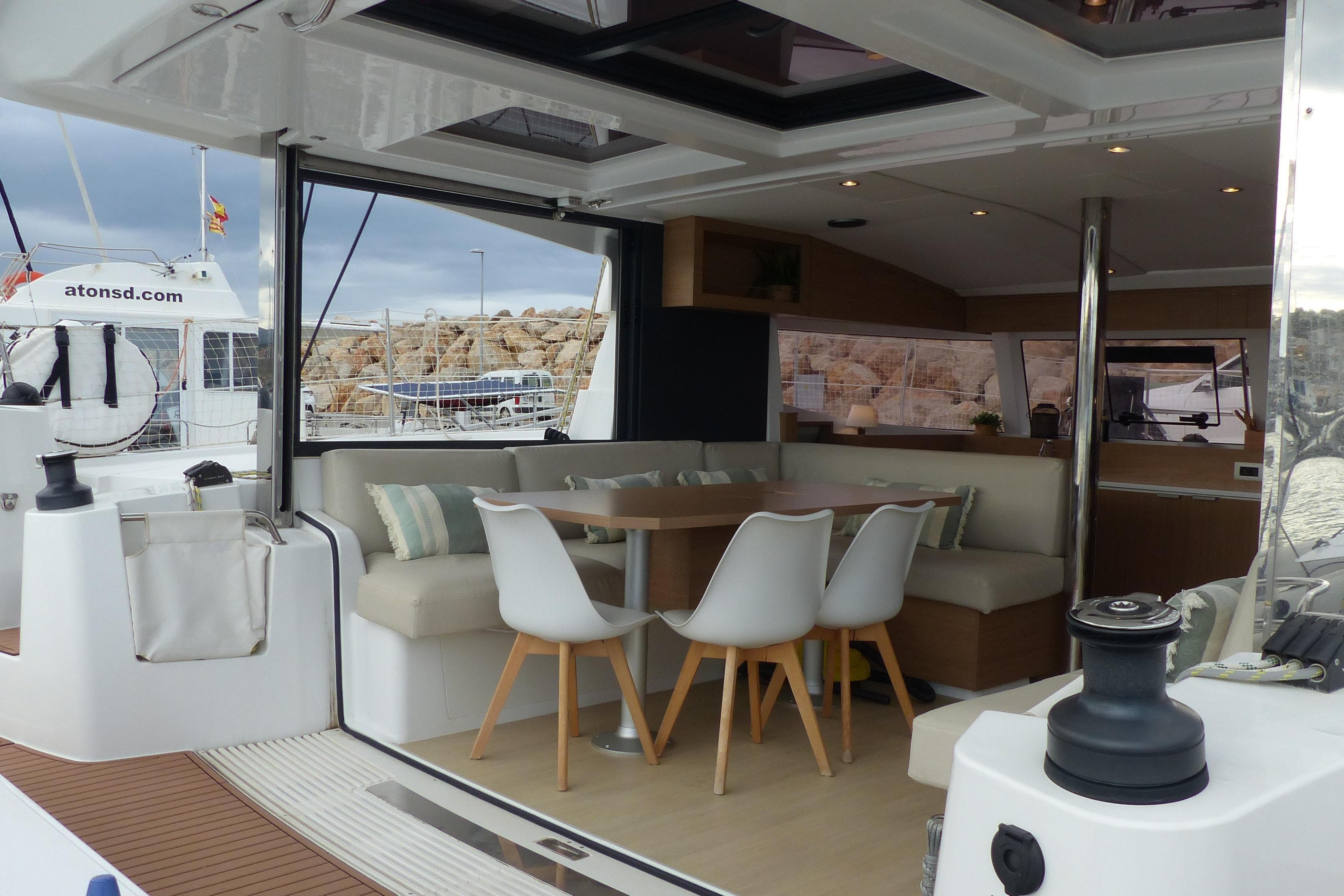 Luxurious 2024 Bali CATSMART yacht interior with modern dining area and comfortable seating.