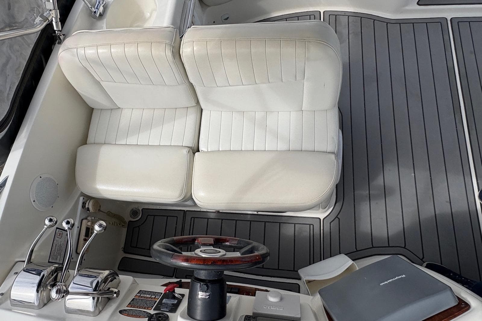 2003 Meridian 411 Sedan helm with white seats and wooden steering wheel.