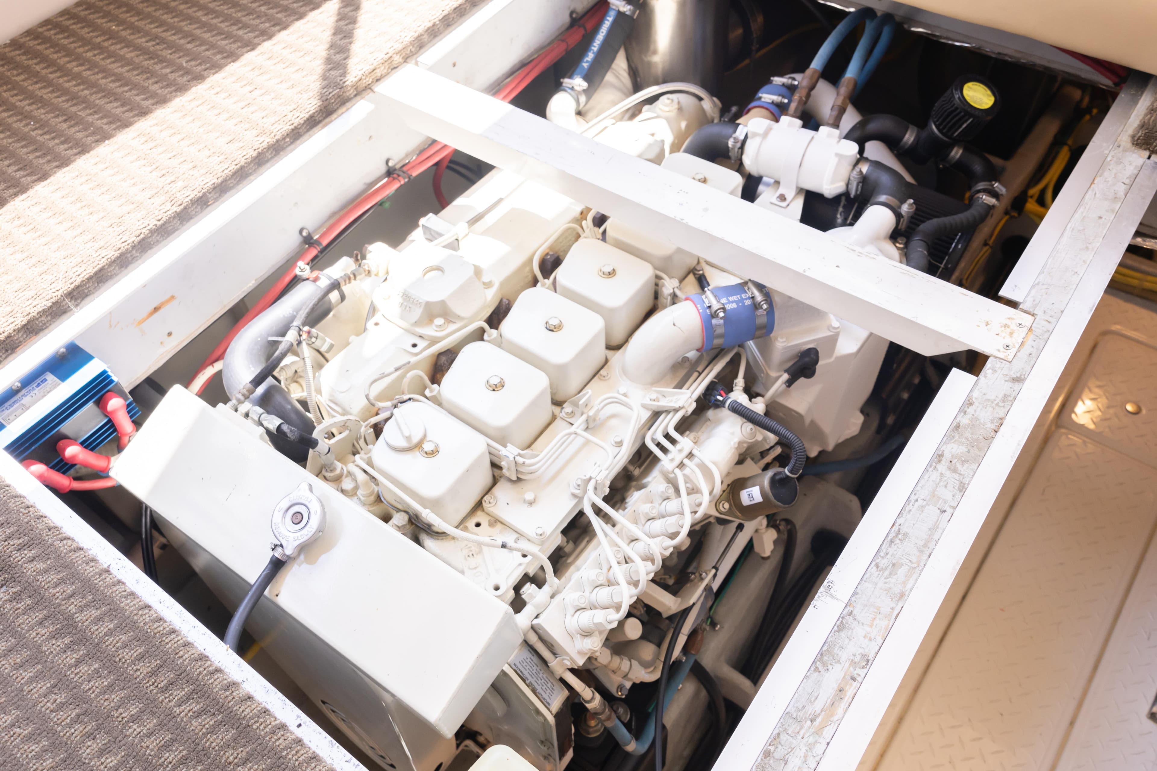 Engine compartment of a 2004 Meridian 490 Pilothouse yacht, showcasing detailed mechanical components.