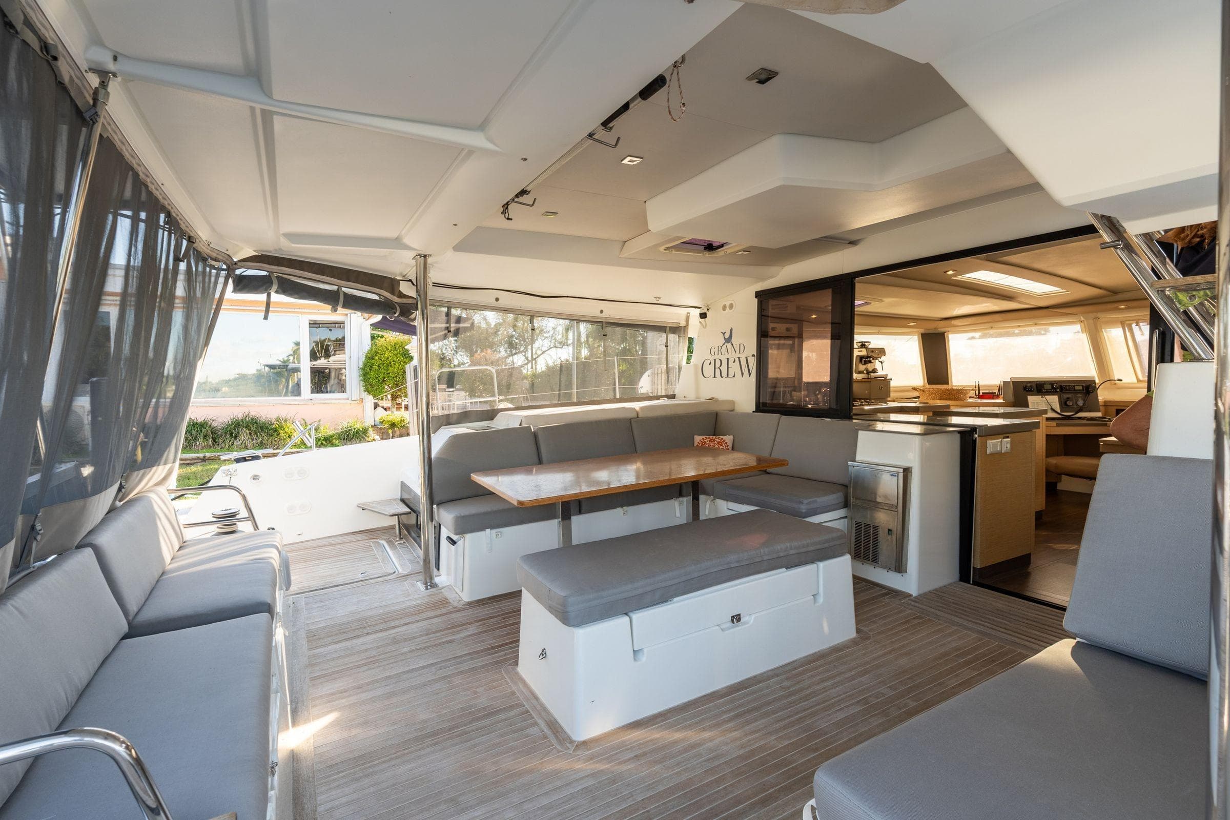 Luxurious interior of 2019 Fountaine Pajot 47 catamaran with spacious seating and dining area.