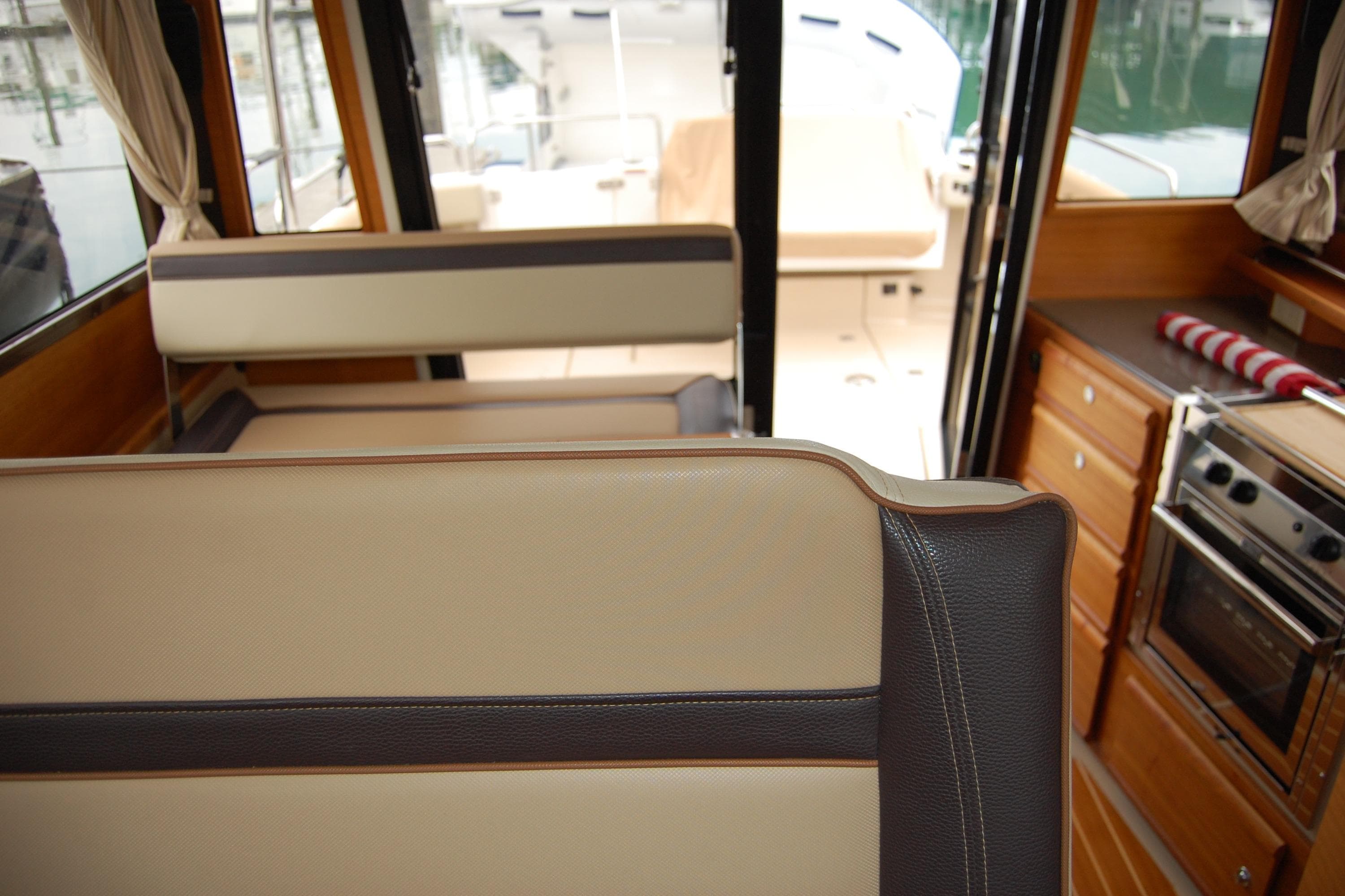 Interior of 2018 Ranger Tugs R29 boat with seating and kitchen area.