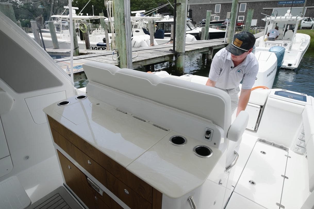 2026 Everglades 367 CX boat interior with seating and storage, docked at marina.