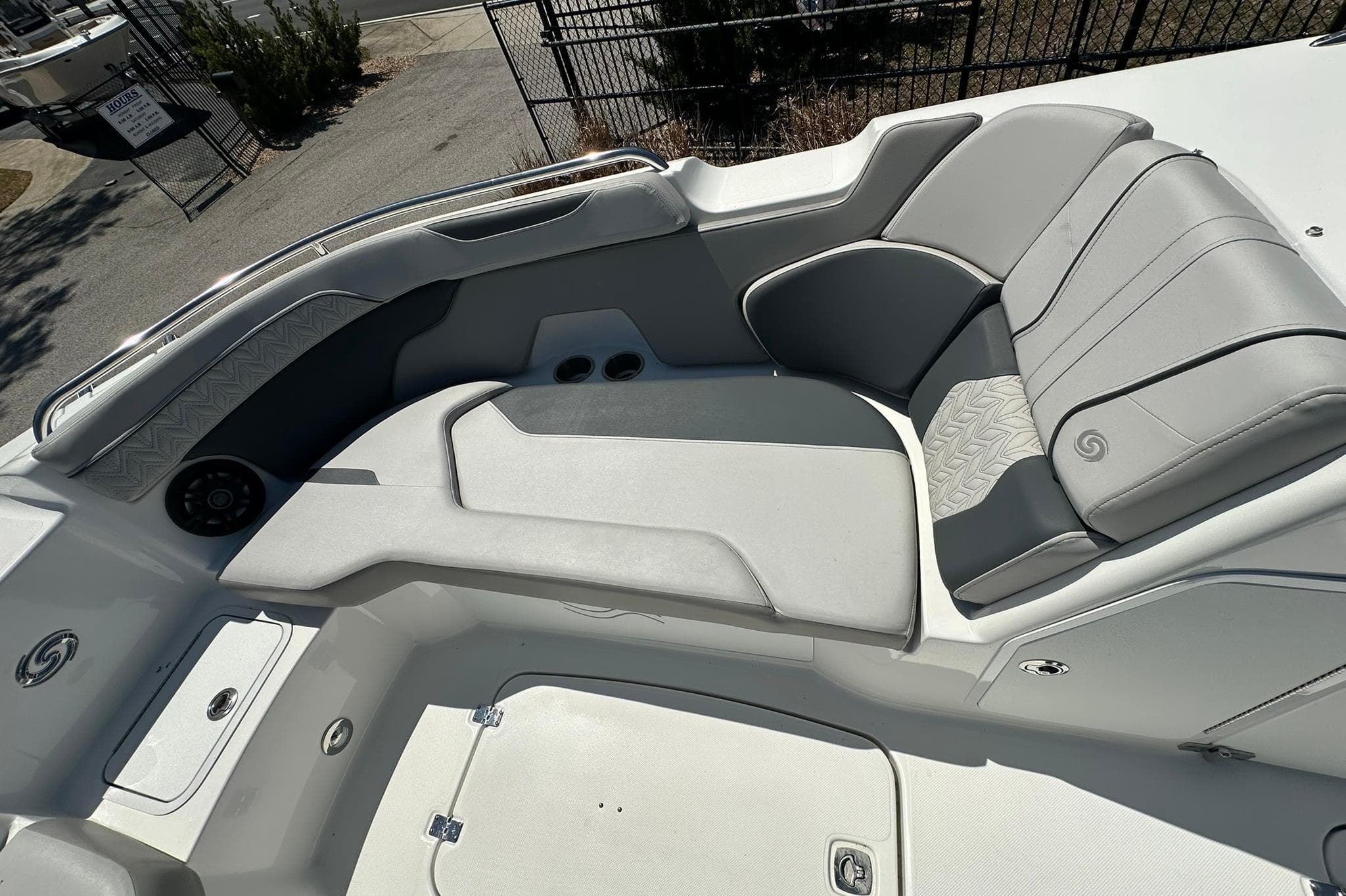 2026 Hurricane SunDeck 2400 OB boat interior with sleek gray seating and modern design.