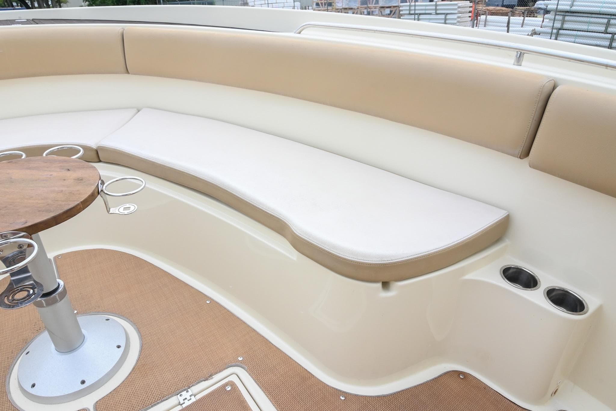 2016 Chris-Craft Catalina 29 interior with beige seating and wooden table.