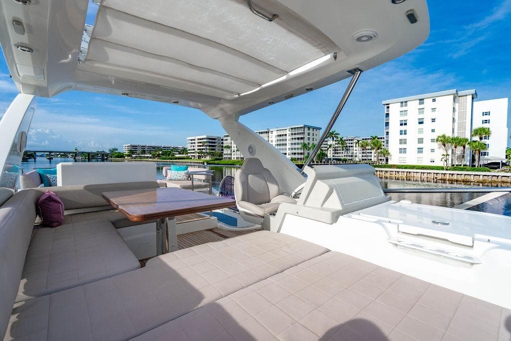 Luxurious 2015 Azimut Fly 50 yacht with spacious seating and scenic waterfront view.