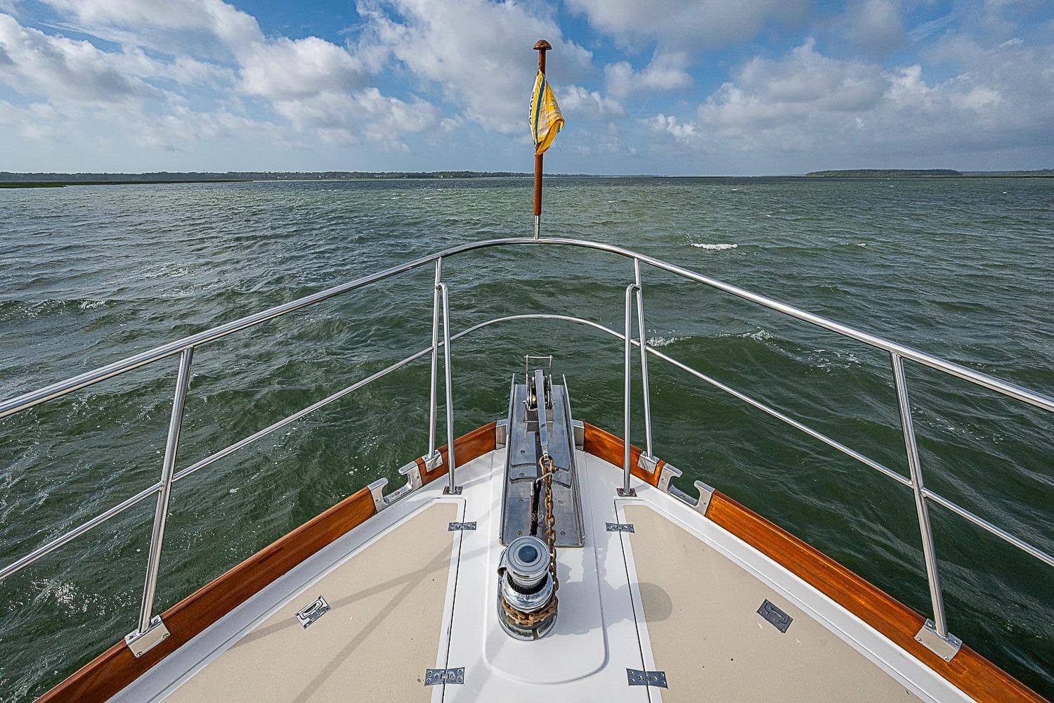 Bow view of 2004 Grand Banks 49 Eastbay HX yacht on open water.