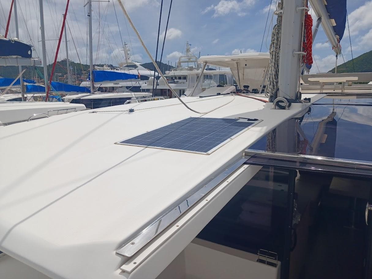 Leopard 50 catamaran, 2020 model, featuring solar panel on deck, docked at marina.