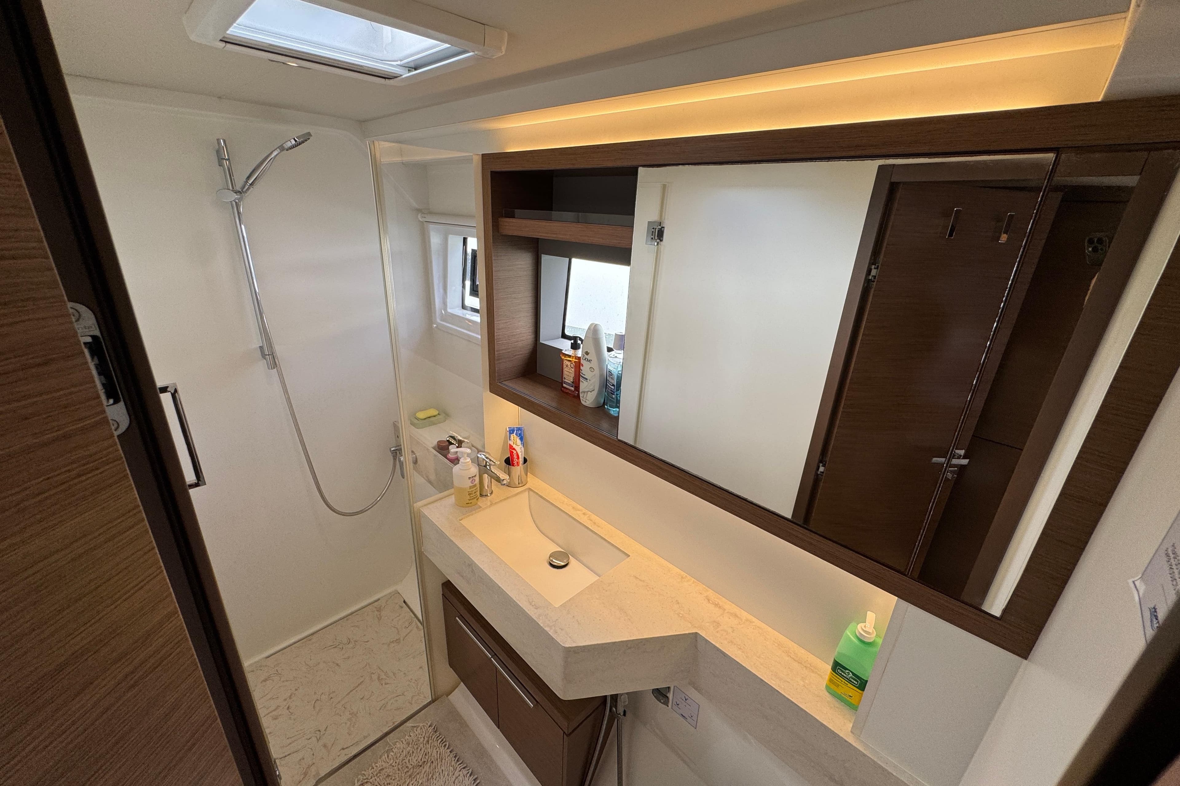 Modern bathroom interior of 2021 Lagoon 50 yacht with sleek fixtures and ample storage.