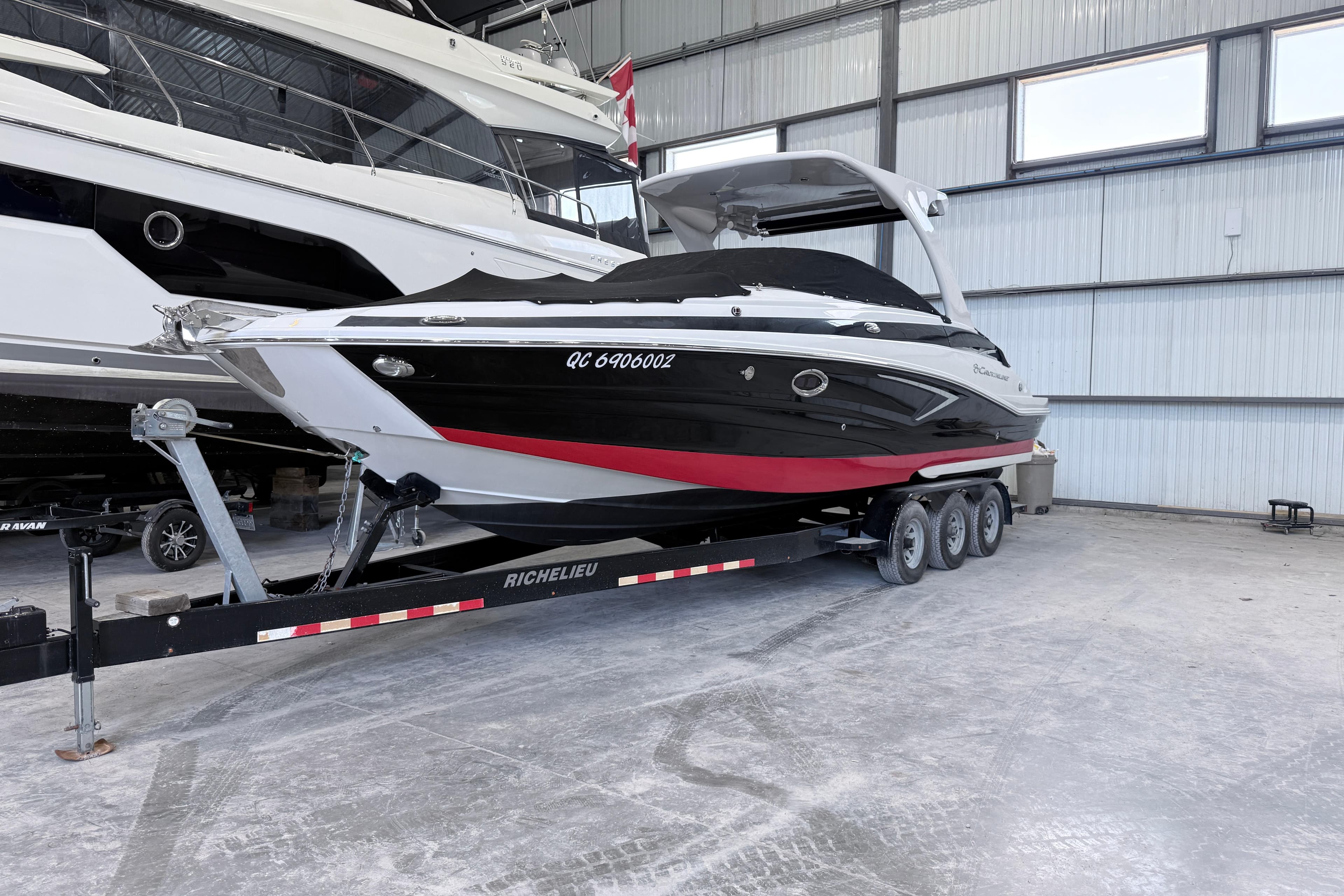 2018 Crownline Eclipse E30 boat on trailer in indoor storage facility.
