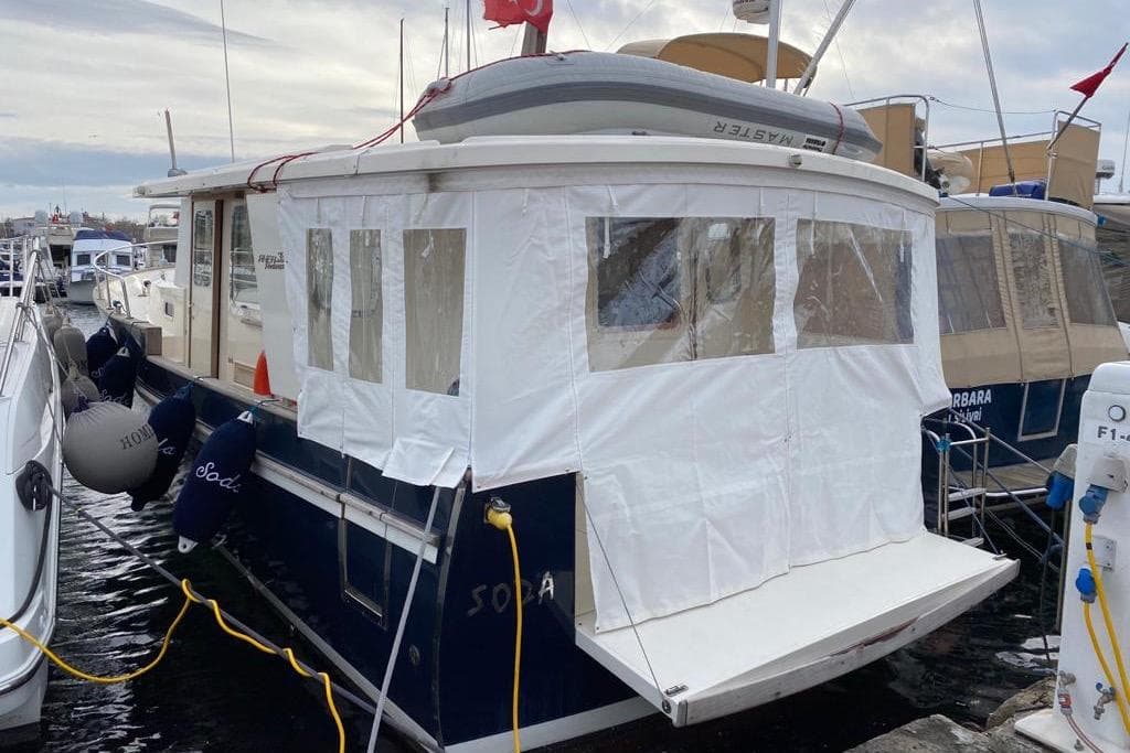 2014 Rhea Trawler 36 Timonier docked with protective cover and visible fenders.