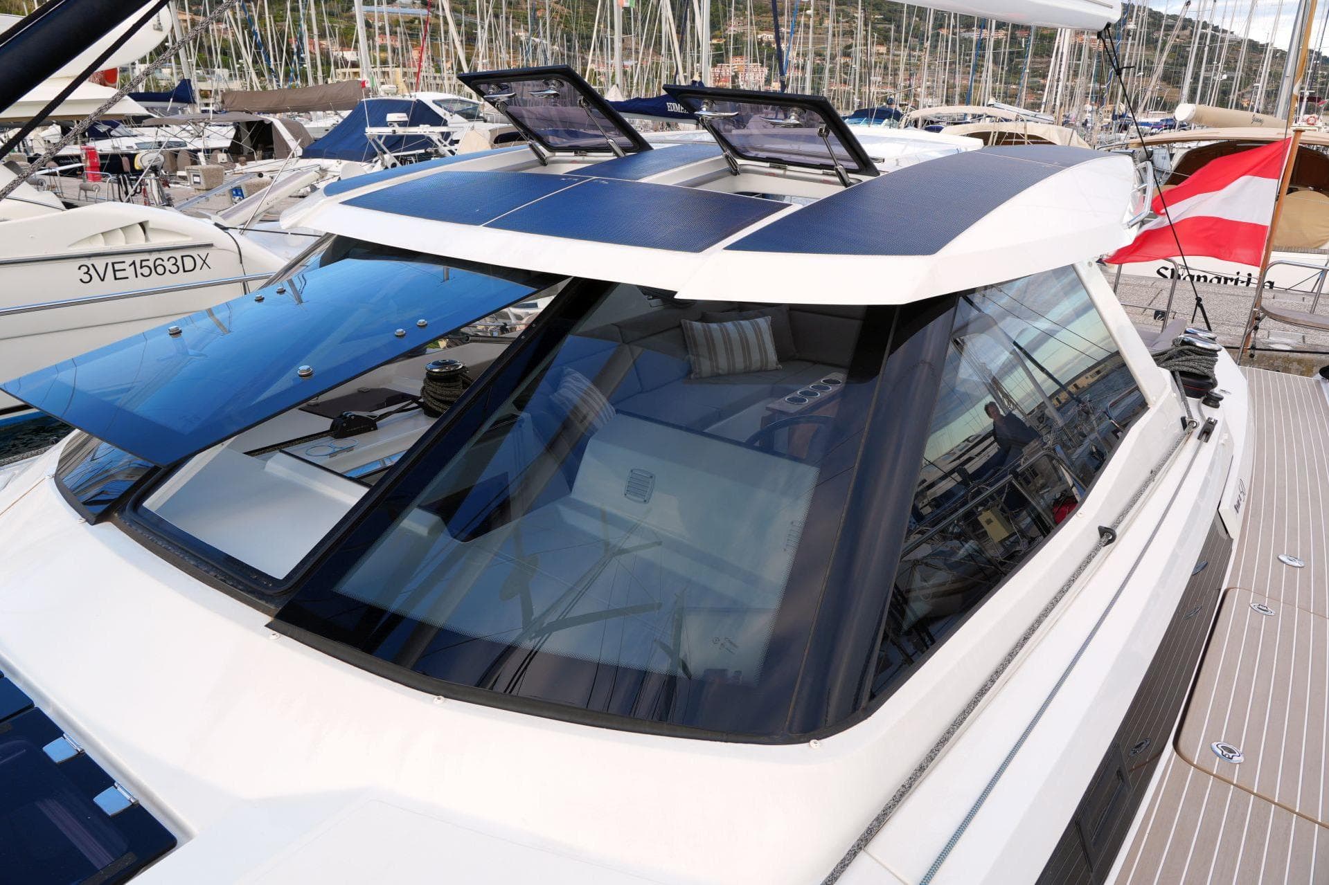 Modern 2023 Amel 50 yacht with solar panels, docked in a marina.