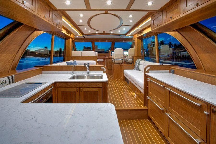 Interior of 2025 Sabre 58 Salon Express yacht with modern kitchen and seating area.