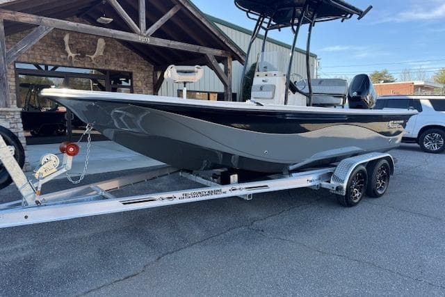 2026 Carolina Skiff 21 LS boat on trailer, parked outside a building.