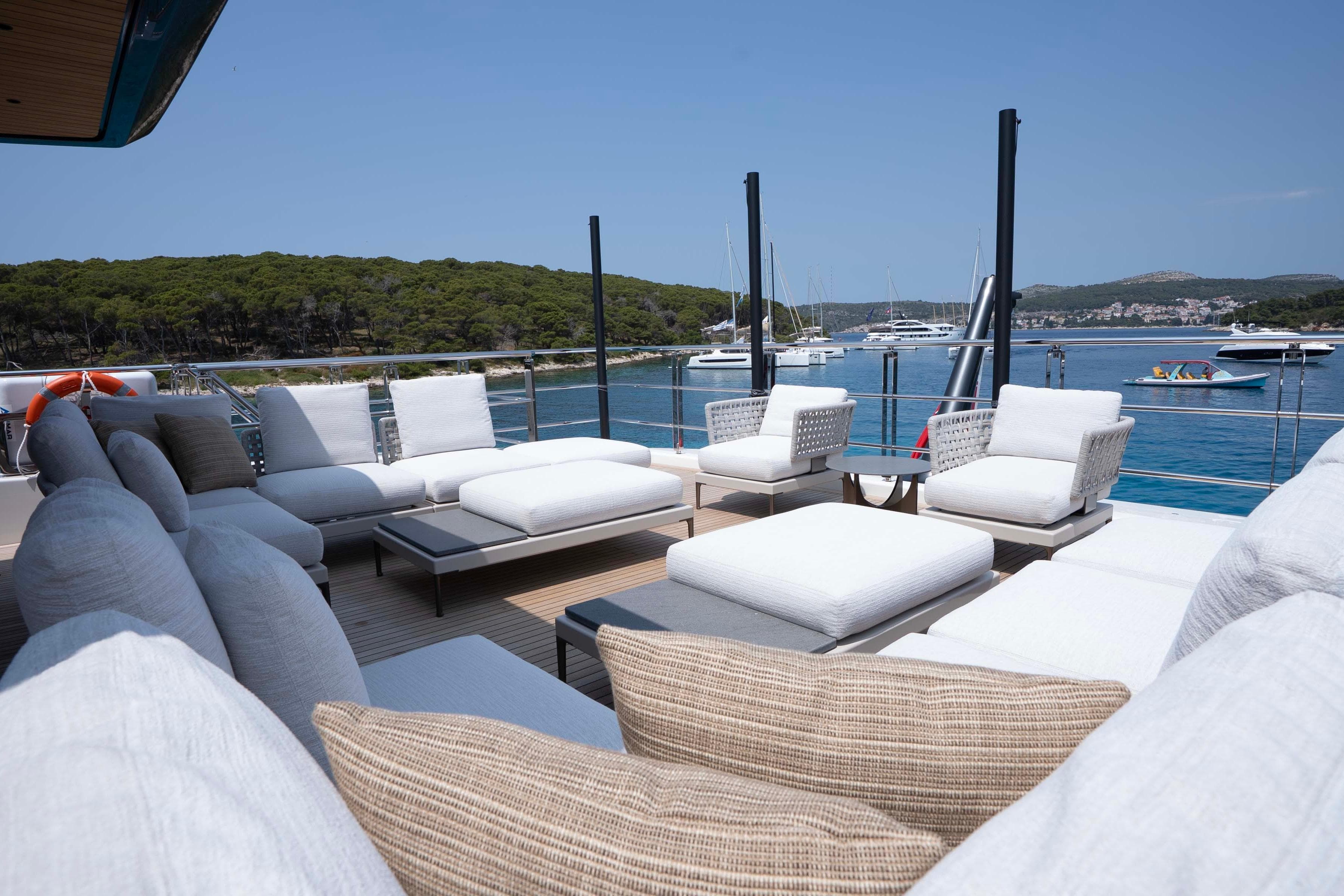 Luxury yacht deck with white sofas, Alpha 100 Squalo Co Ownership 2025.