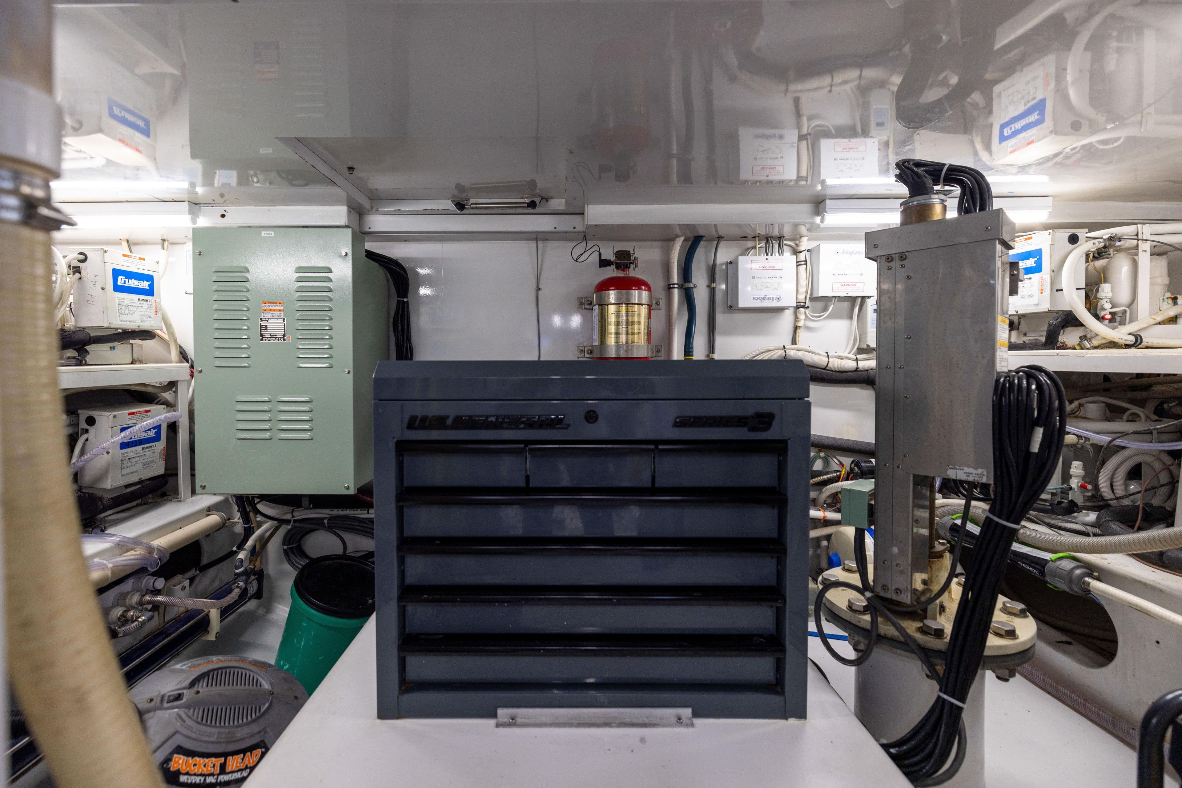 Engine room of 1996 Jim Smith 60 Sportfish with tool chest and equipment.