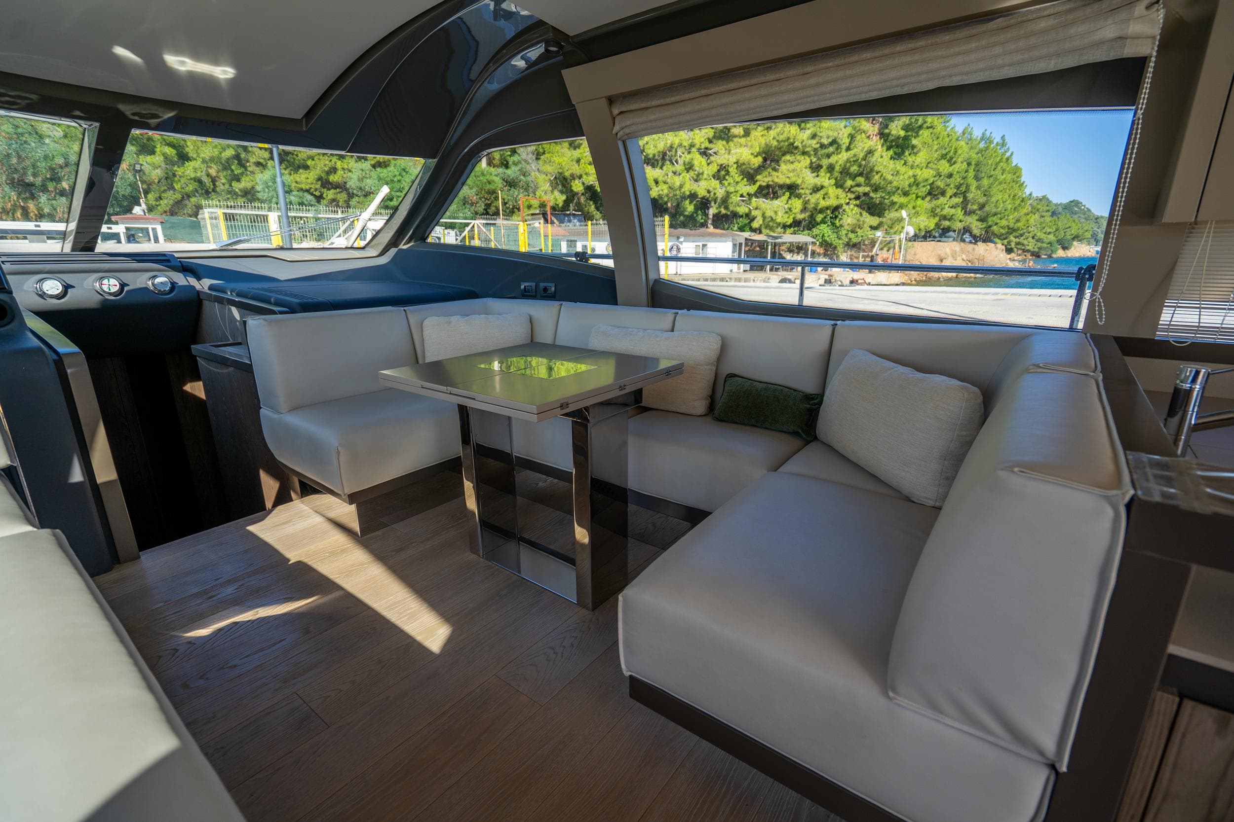 Luxurious interior of 2021 Ferretti Yachts 550 with elegant seating and scenic window view.