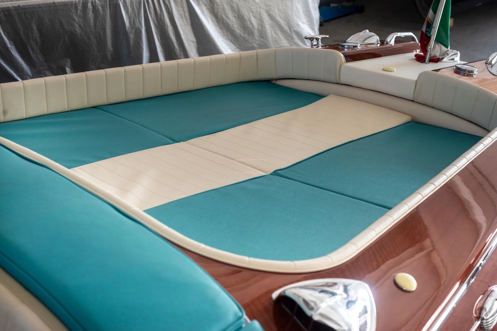 1967 Riva Aquarama boat interior with turquoise and white upholstery, showcasing classic luxury design.