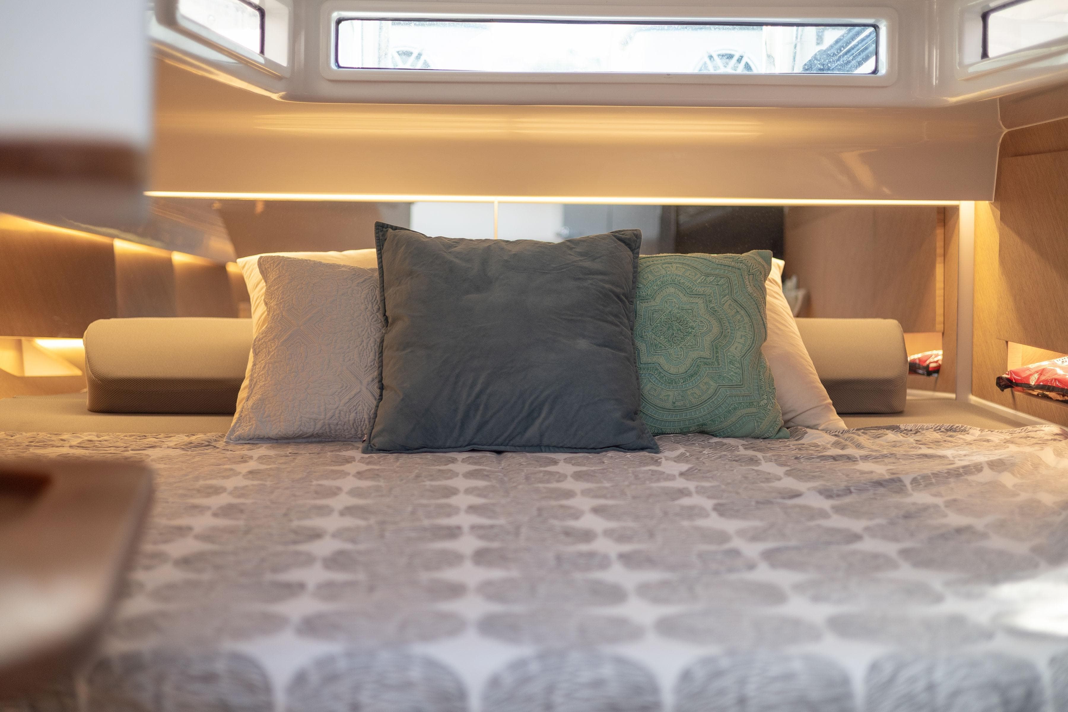 Luxurious cabin interior of 2022 Frauscher 1414 Demon Air yacht with cozy bedding.