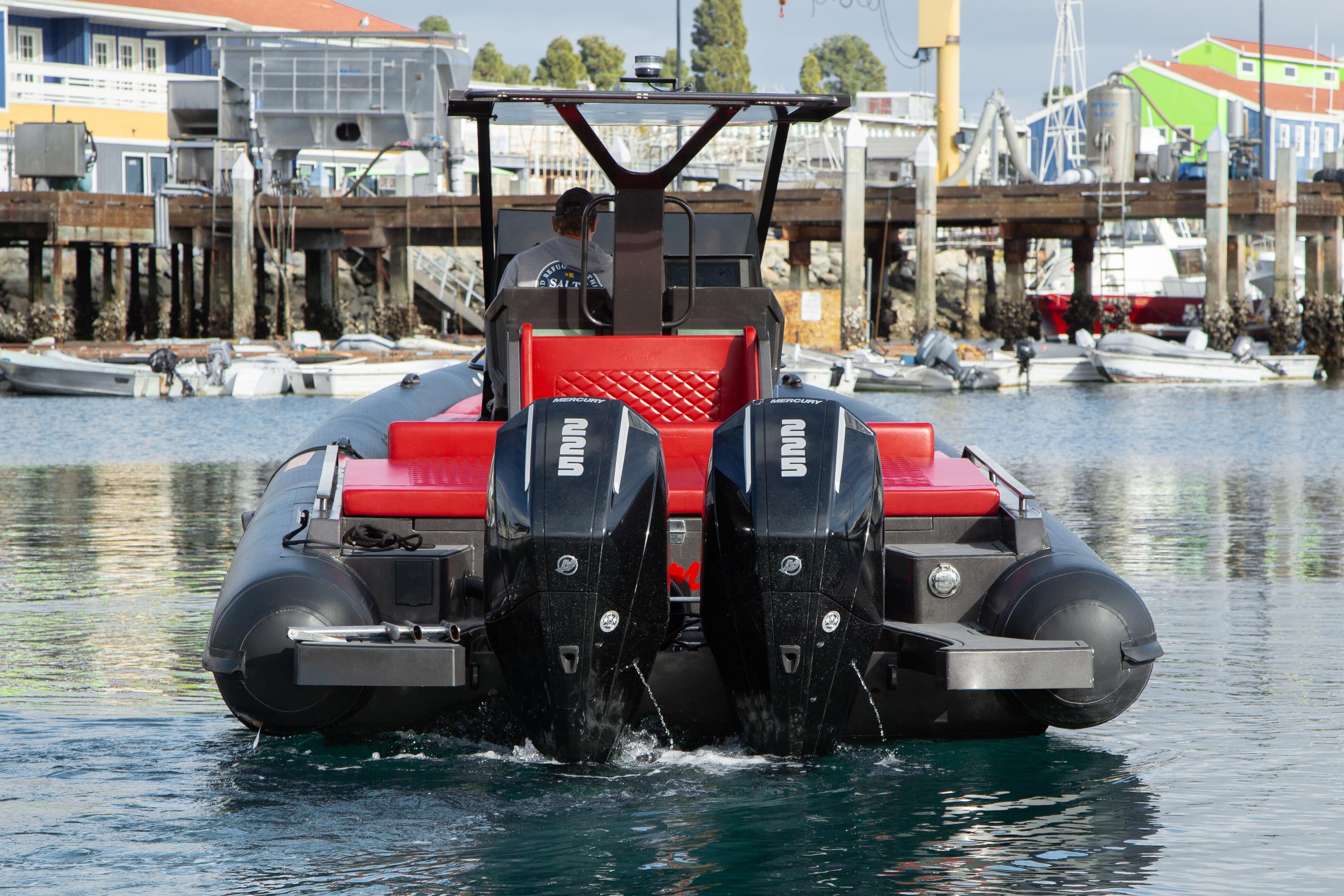 2023 Novielli Veloche 349 boat with dual outboard motors in a marina setting.