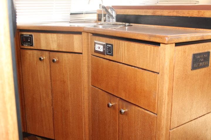 1997 Bayliner 4087 Aft Cabin Motoryacht kitchen with wooden cabinets and sink.