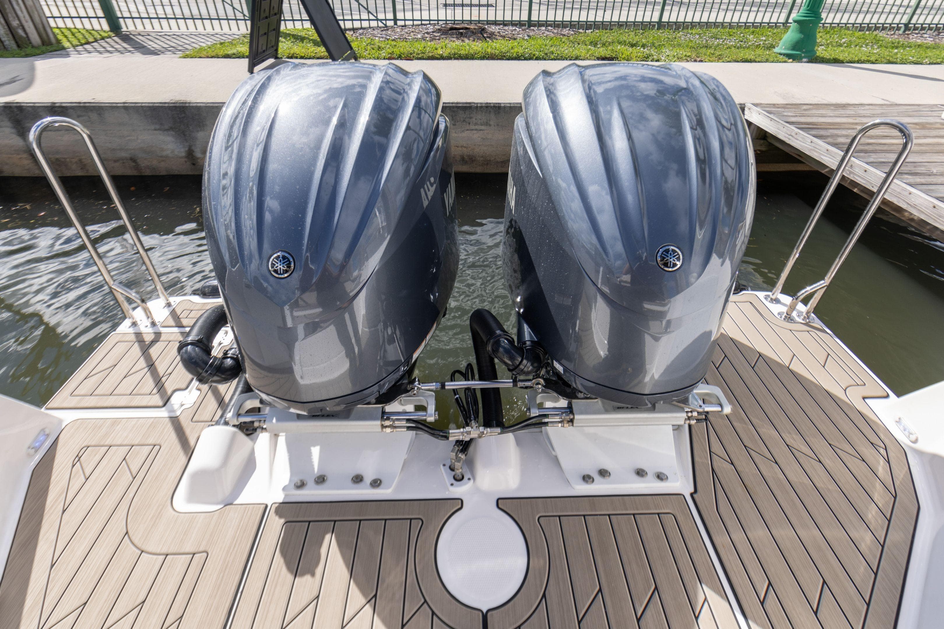 2026 Cutwater C-288 Coupe with dual outboard engines on a wooden deck.