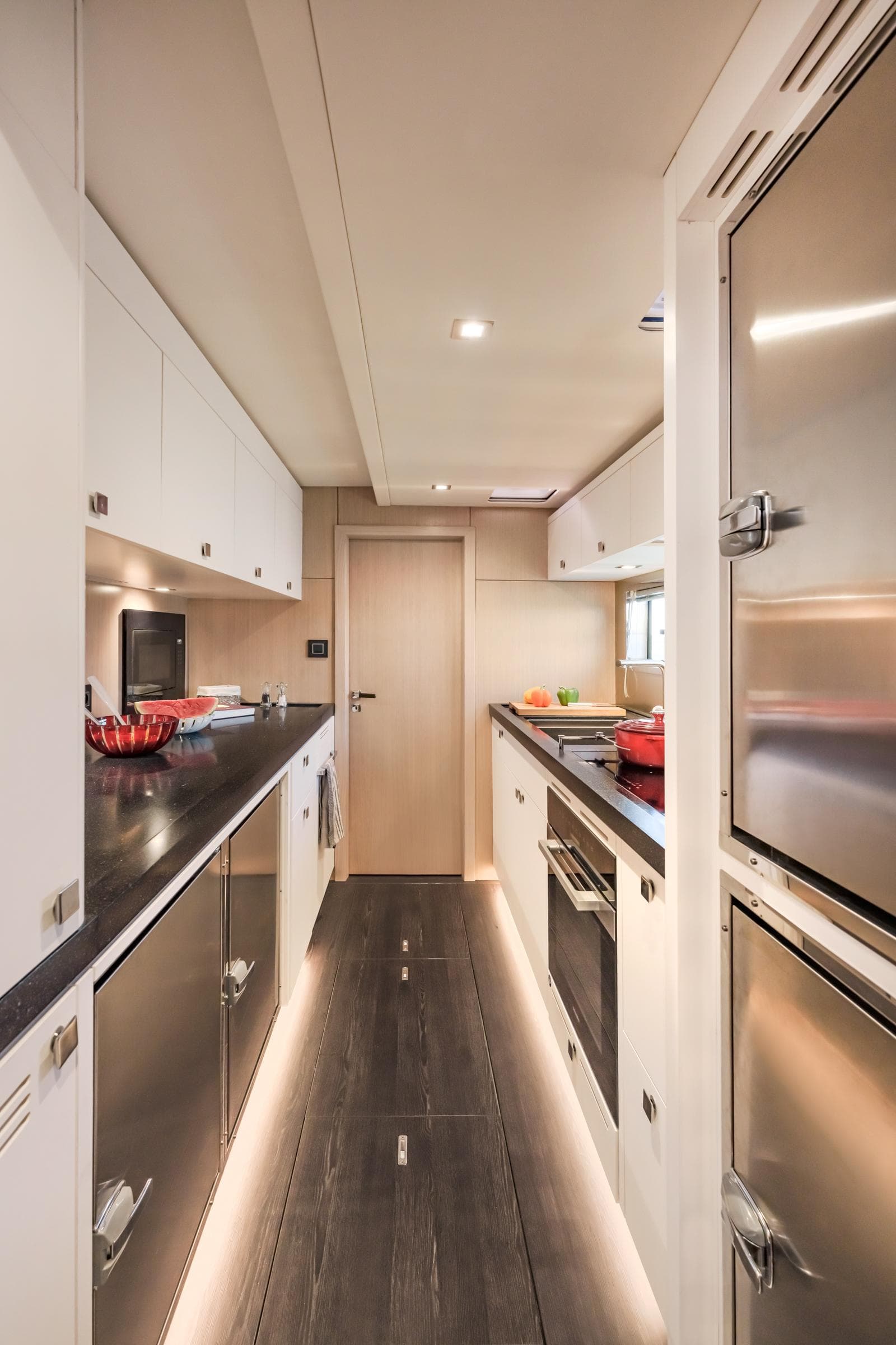 Luxurious galley kitchen in 2025 Privilege Signature 650 yacht, featuring modern appliances and sleek design.