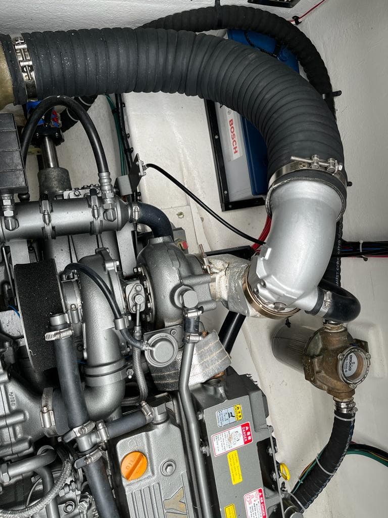 Engine compartment of 2022 Kelsall KSS P65 with hoses and valves.