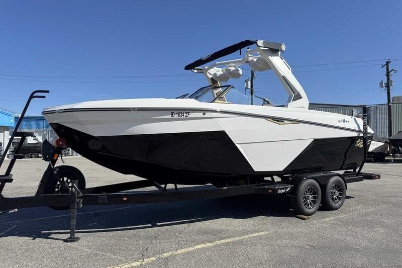 2026 Tigé Z3 boat on trailer, black and white design, parked outdoors.