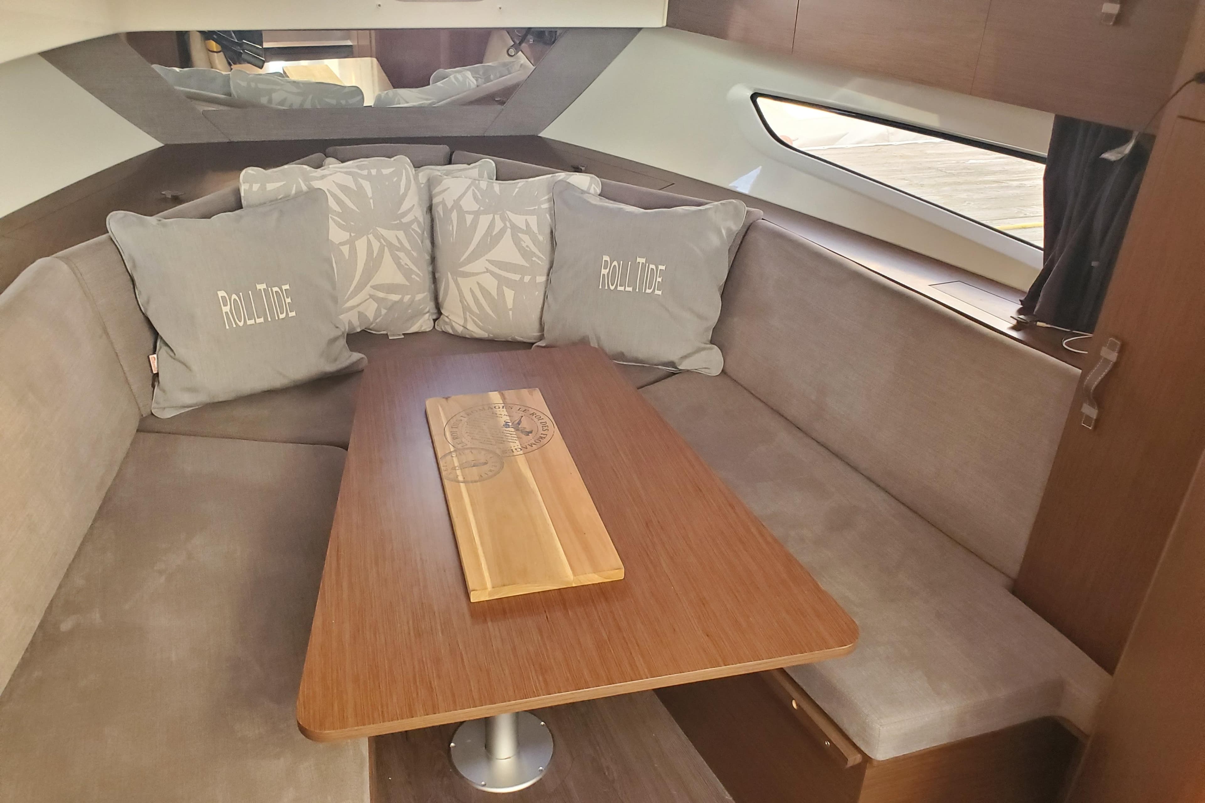 Interior of 2021 Beneteau Flyer 10 with cozy seating and decorative pillows.
