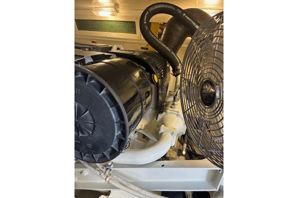 Engine compartment of a 2004 Silverton 48 Convertible yacht, featuring hoses and fan.